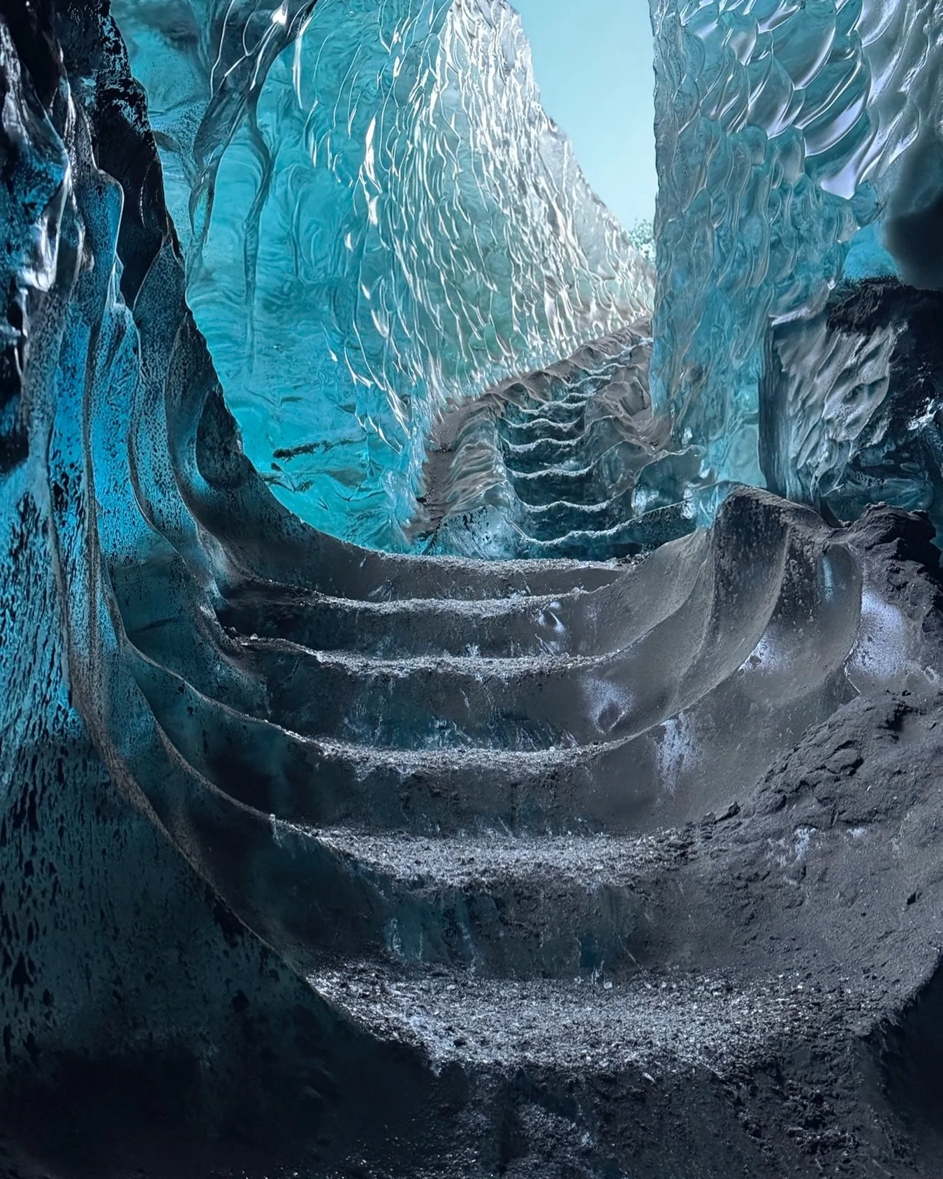Discover the breathtaking beauty of an Iceland ice cave, where glowing blue ice, sculpted glacial walls, and natural crystal formations create a surreal underground world. This stunning frozen cave in Iceland showcases the island&rsquo;s dramatic win