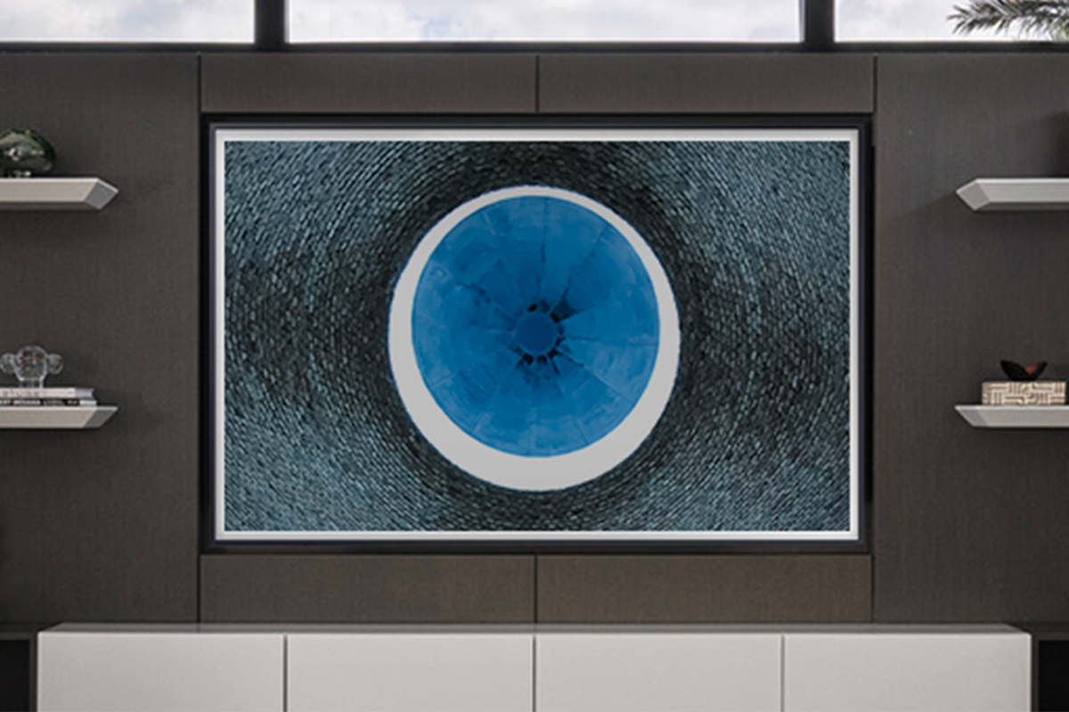 Abstract architectural photograph featuring a circular blue form centered within textured surfaces, framed and displayed in a modern interior by Jay Britto.