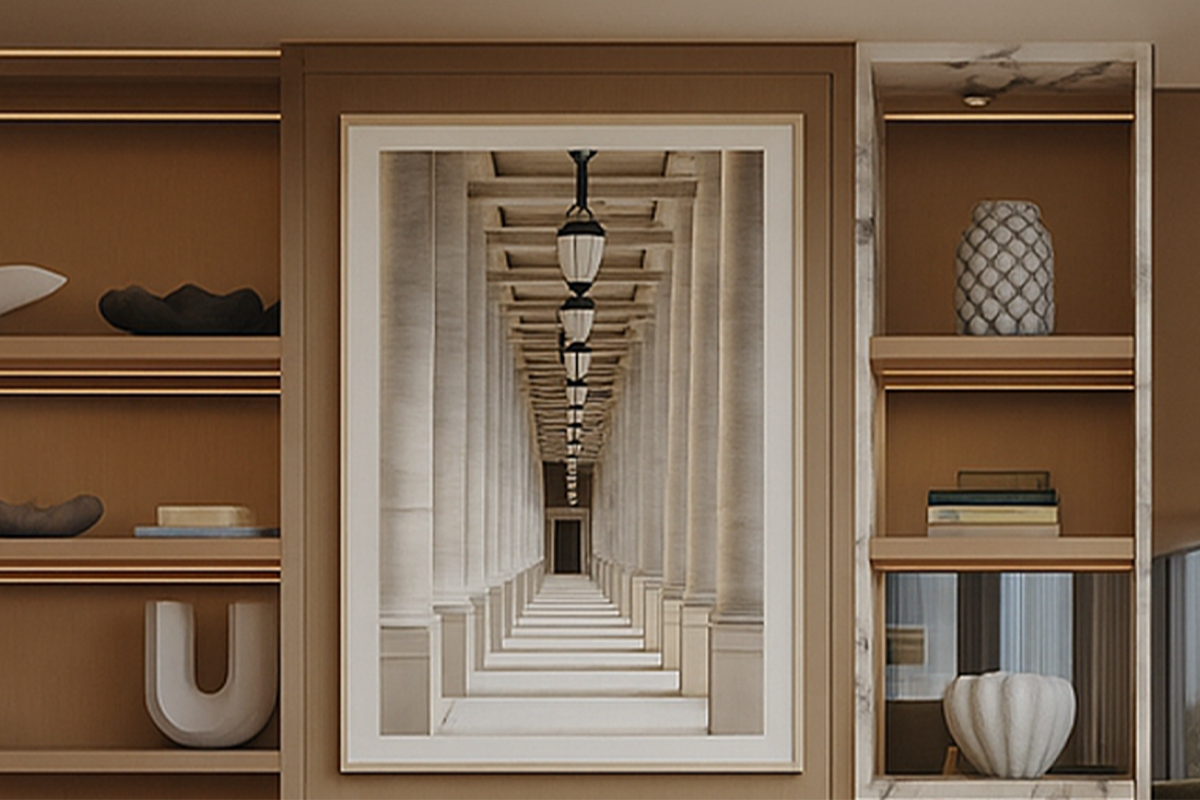 Architectural photograph of a symmetrical colonnade with repeating arches and strong perspective, framed within a warm, modern interior by Jay Britto.