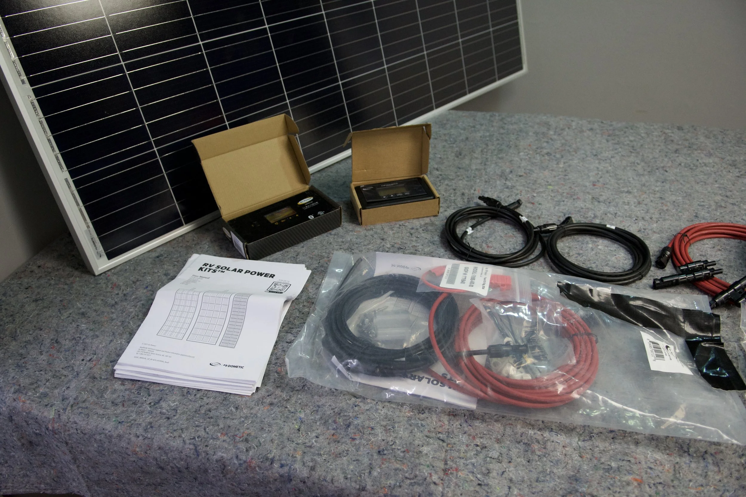 Red and black MC4 cables, fuse kit, and mounting hardware for Go Power RV solar installation
