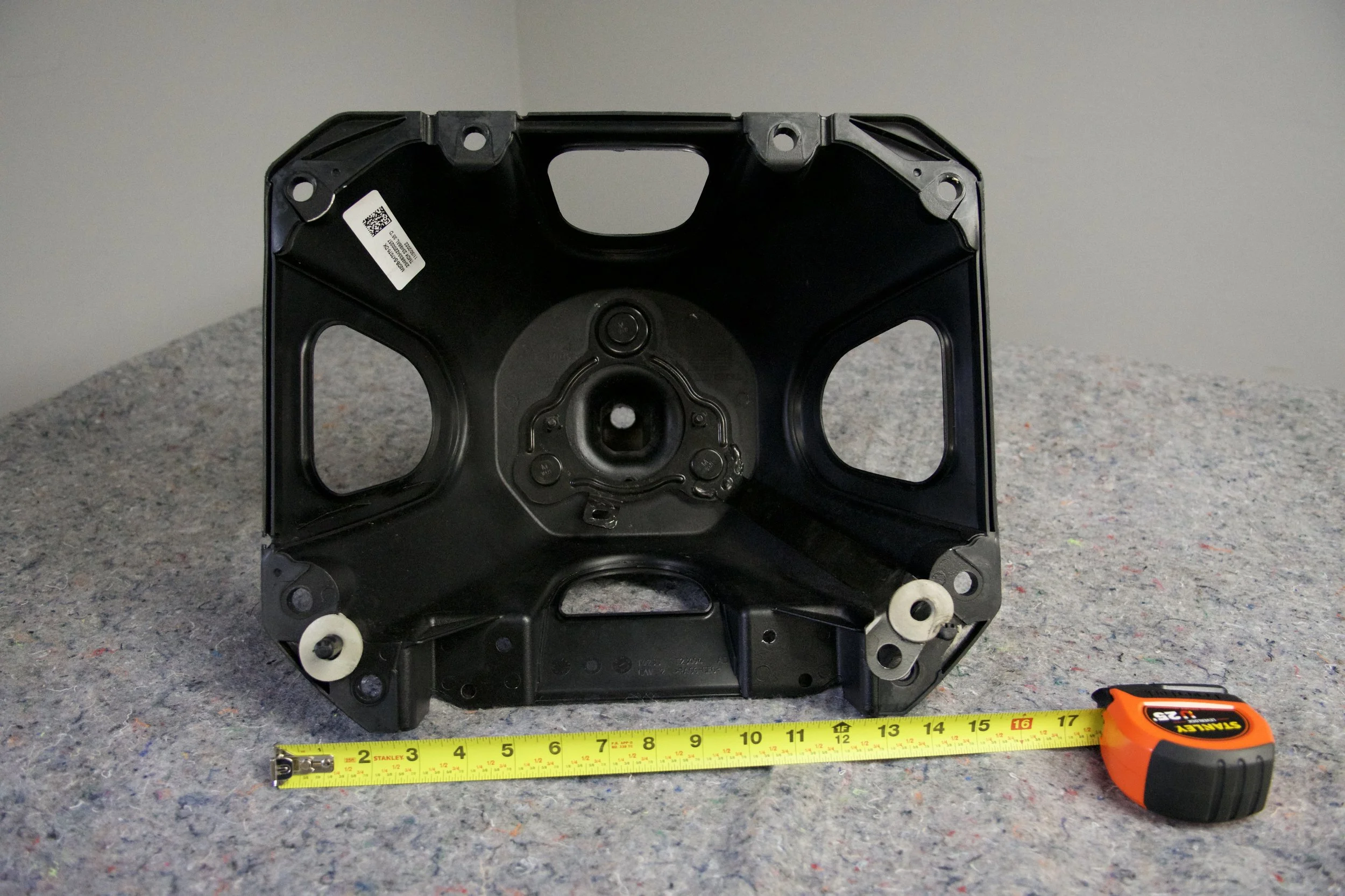 Ford Bronco 6G OEM spare tire holder – factory take-off part (#6011) shown on display table, no mounting hardware included