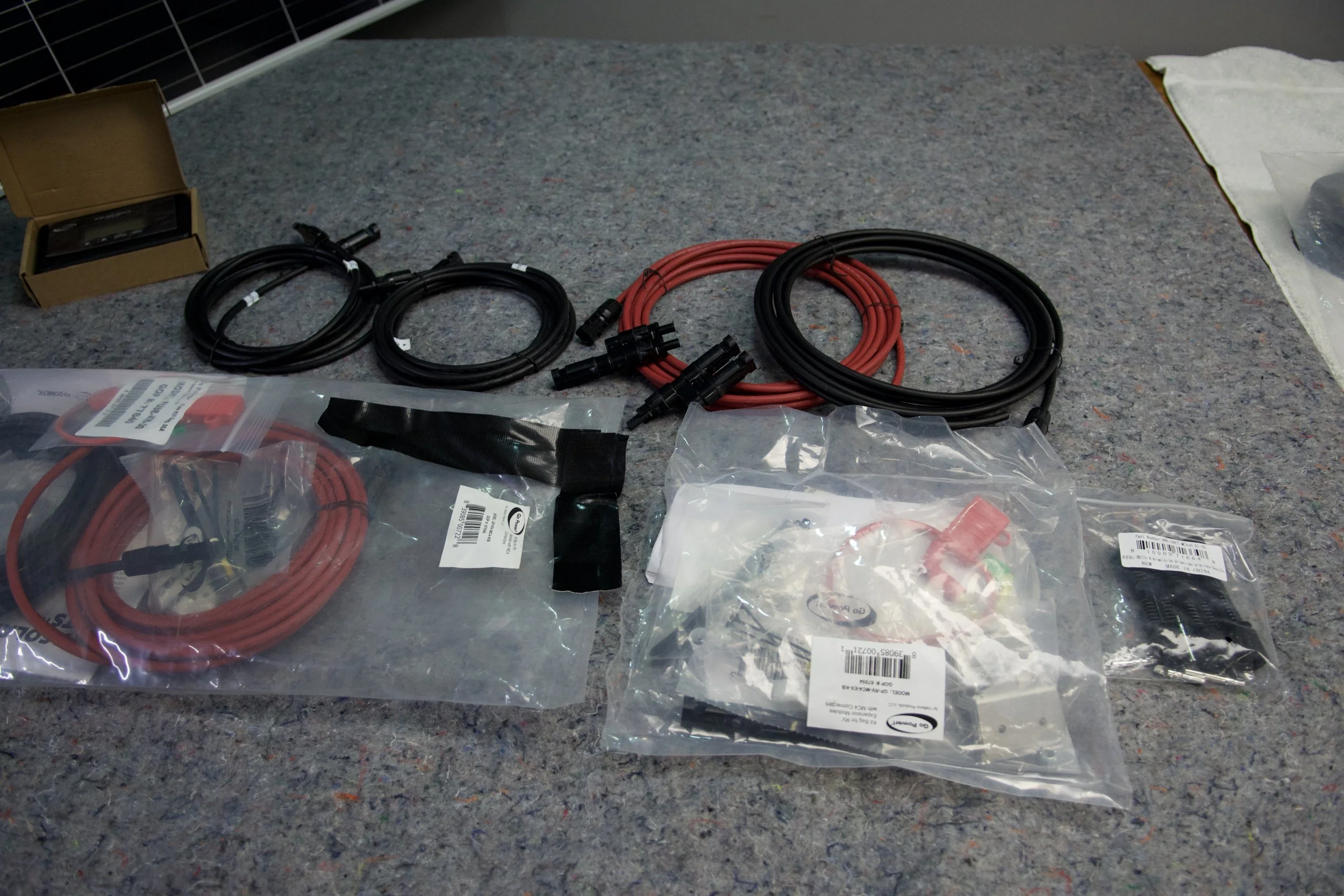 Red and black MC4 cables, fuse kit, and mounting hardware for Go Power RV solar installation