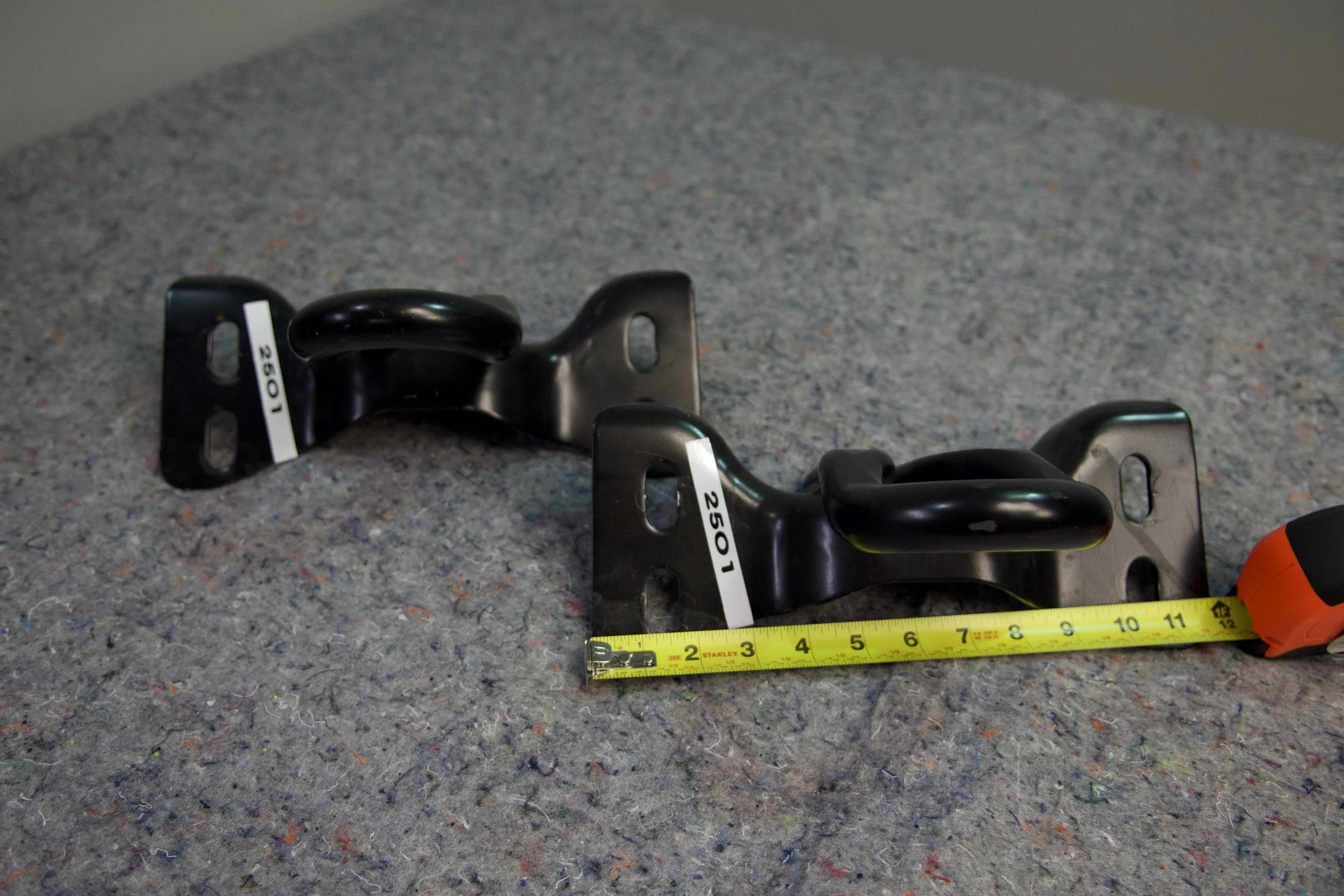 Close-up view of Ford Performance M-18954-SDR heavy-duty tow hooks for 2022 Ford Super Duty, designed for secure towing and vehicle recovery.