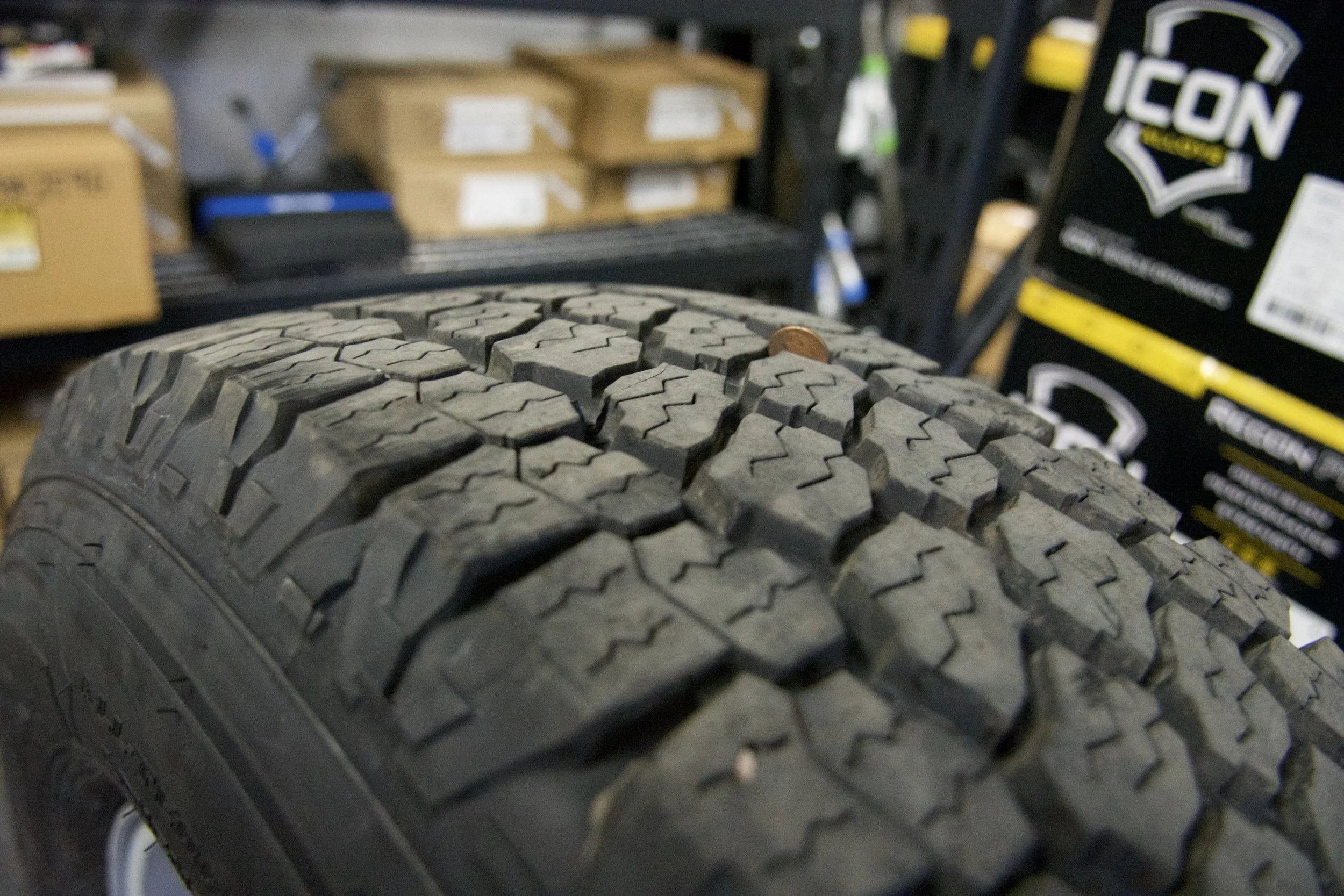 Brand new Goodyear Wrangler All-Terrain Adventure tire mounted on silver multi-spoke alloy rim, ready for 4x4 trucks or classic Bronco builds.