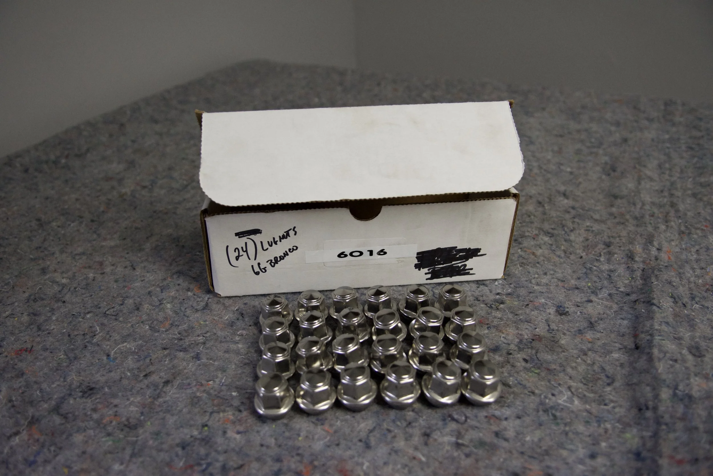 Close-up view of 24 factory Ford Bronco 6G lug nuts
