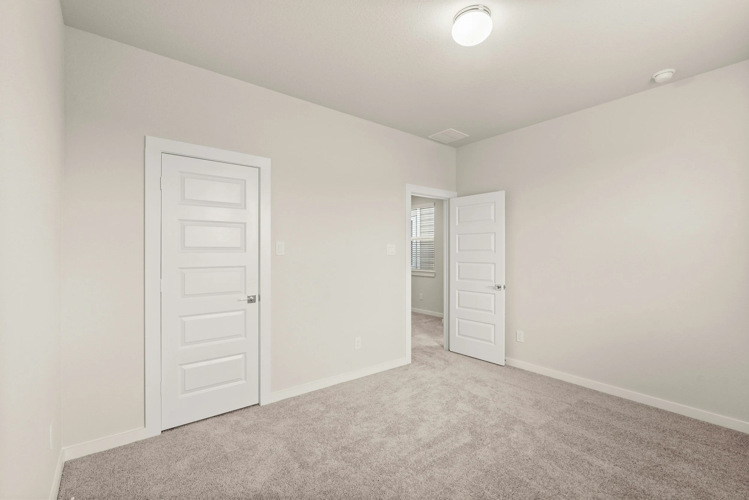 alt="Wall painted in warm white and wood floors refinished for a clean move-in ready look"