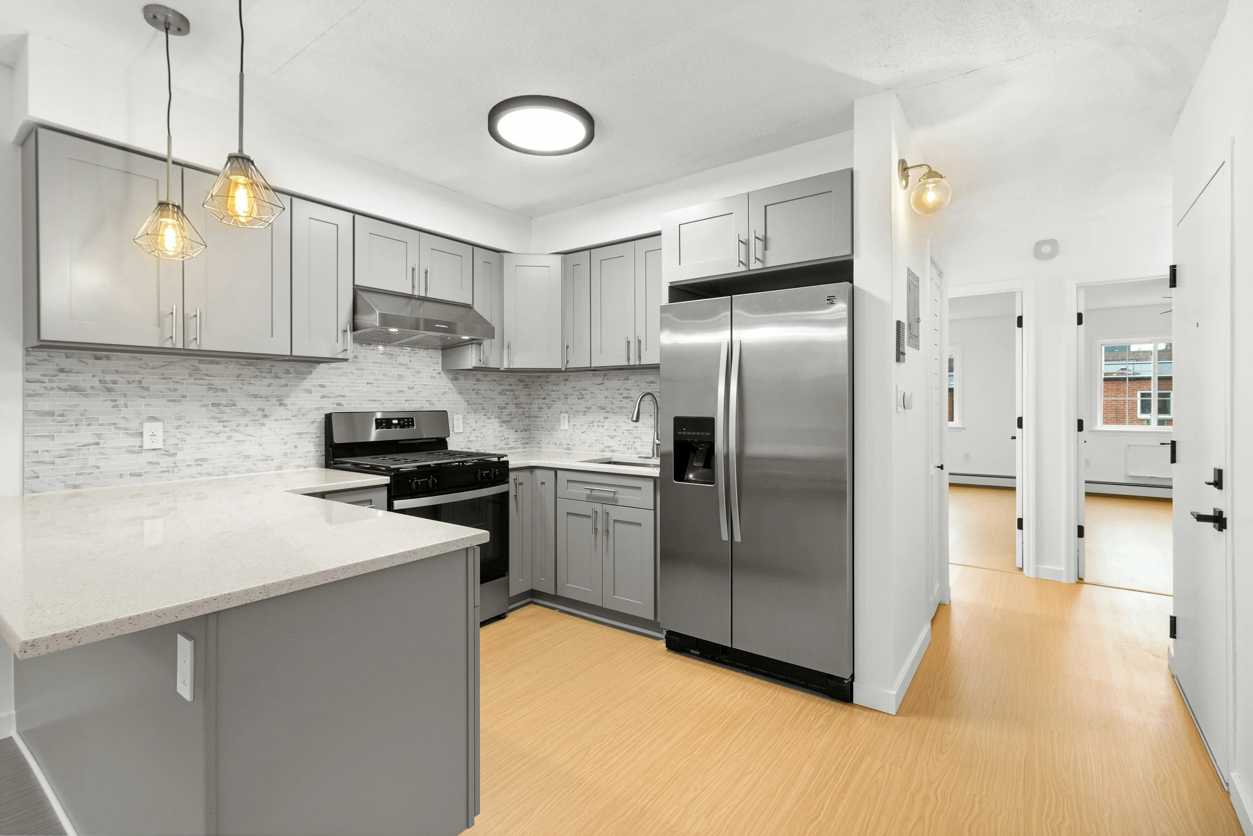 alt="Homeowner and contractor walking through property, pointing at areas to be remodeled"