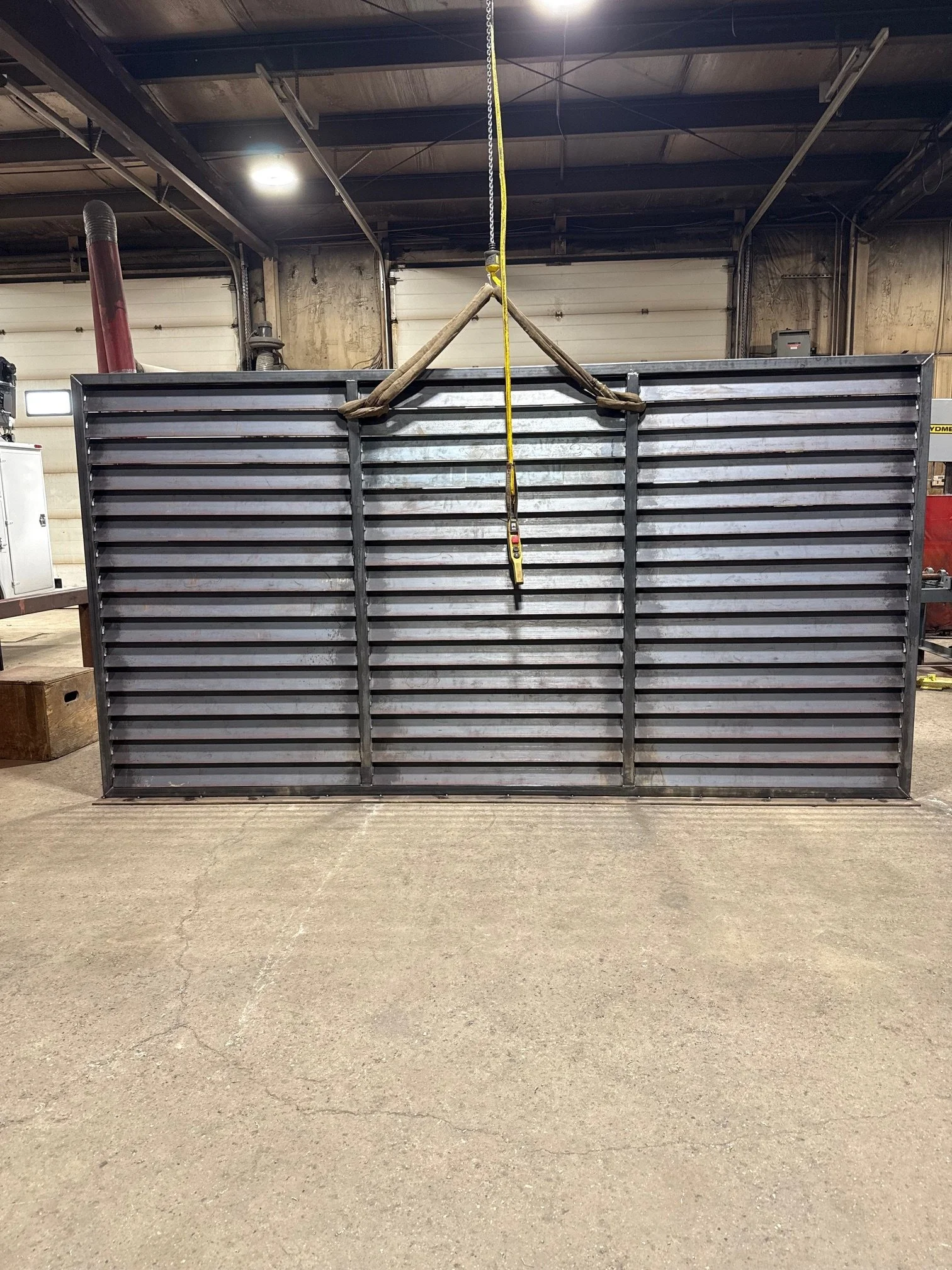 Industrial metal structure in a warehouse with a lifting strap attached at the top