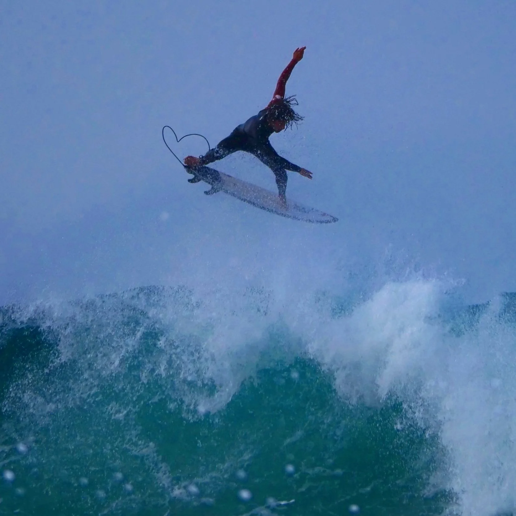 Surfer boosting air Costa Caparica Portugal