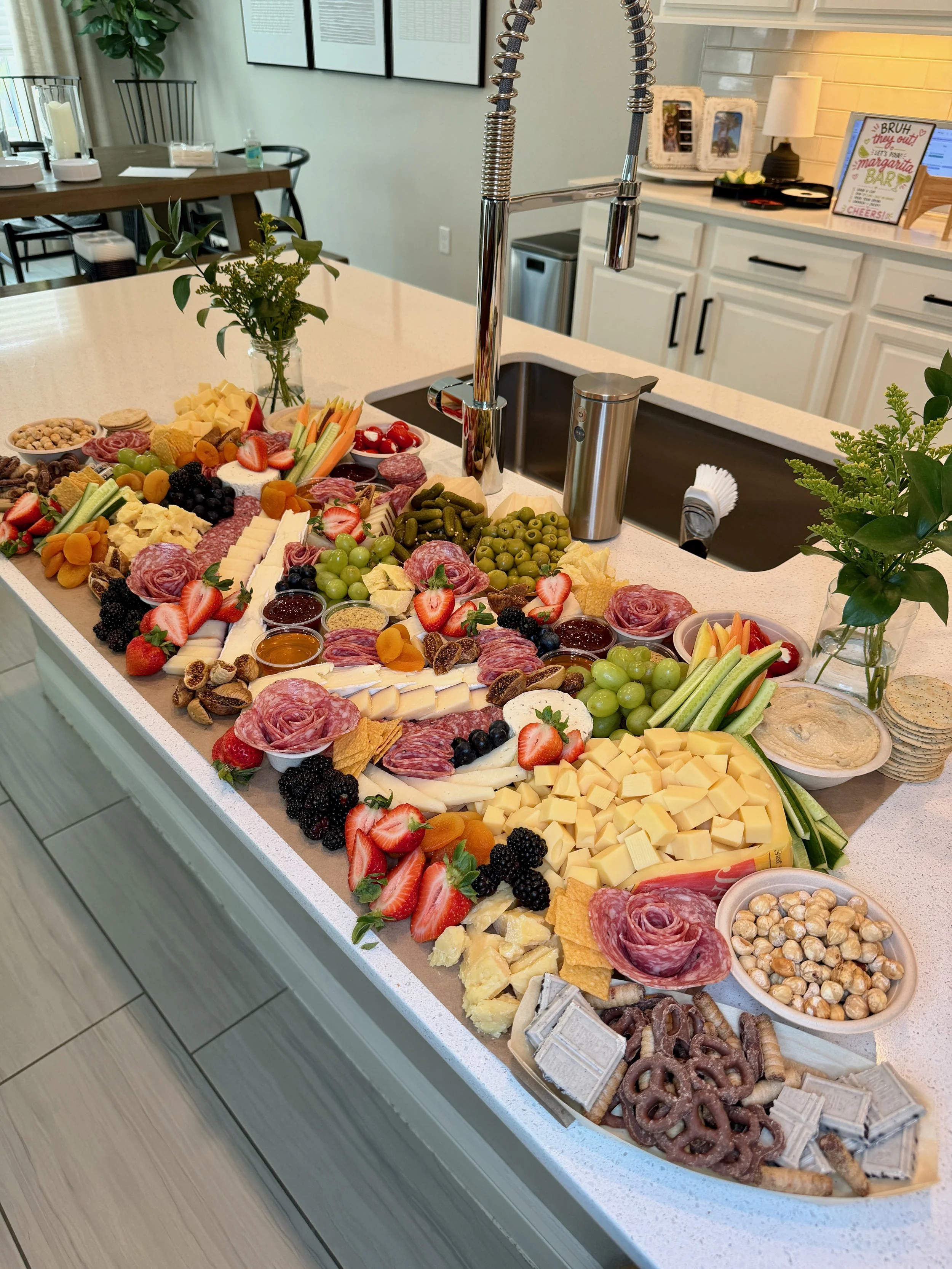 Flat lay grazing table with artisan cheeses, charcuterie, and seasonal fruit in St. Augustine, Florida.