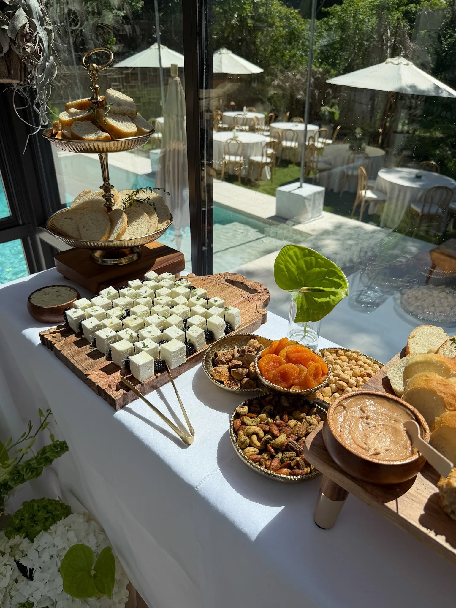 Fresh catering display featuring artisan cheeses, seasonal fruit, honeycomb, and charcuterie in St. Johns County, Florida.