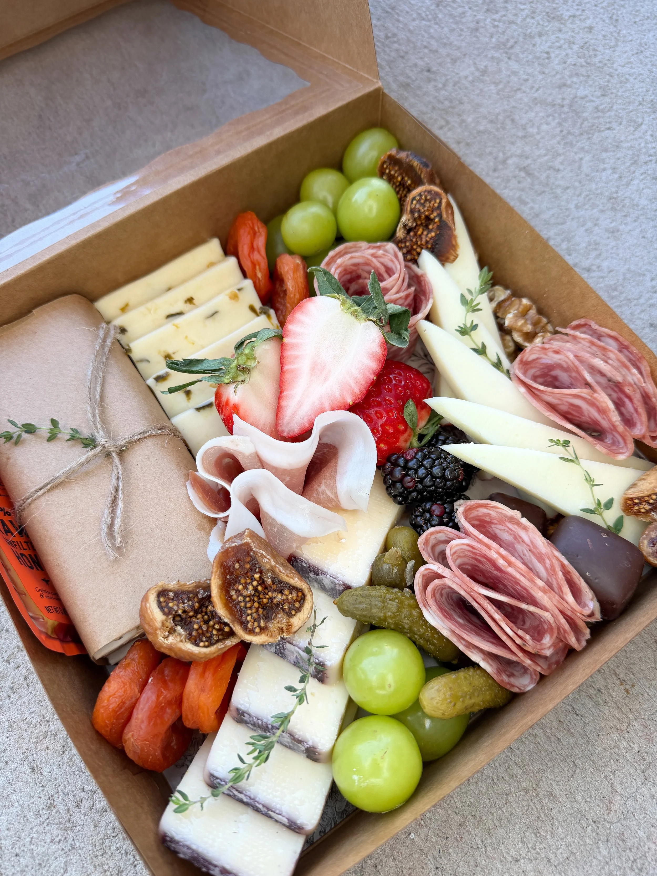 Snackin Box charcuterie box for two with artisan cheeses, cured meats, crackers and fresh fruit, available for local pickup or delivery in St. Johns County, Nocatee, Ponte Vedra, Ponte Vedra Beach, St. Augustine and Jacksonville FL