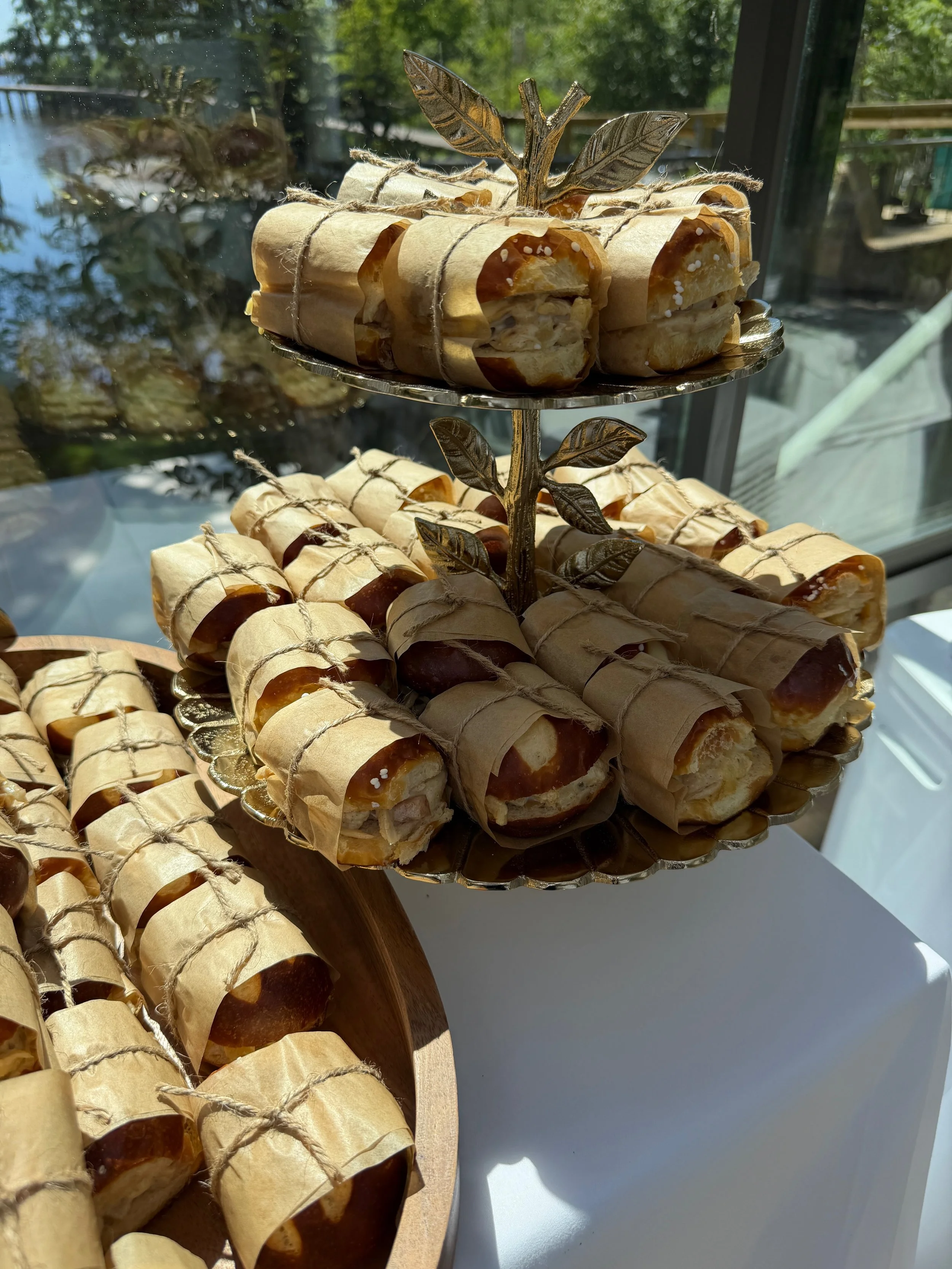 Decorative tray holding wrapped caramel candies inside a glass display case.