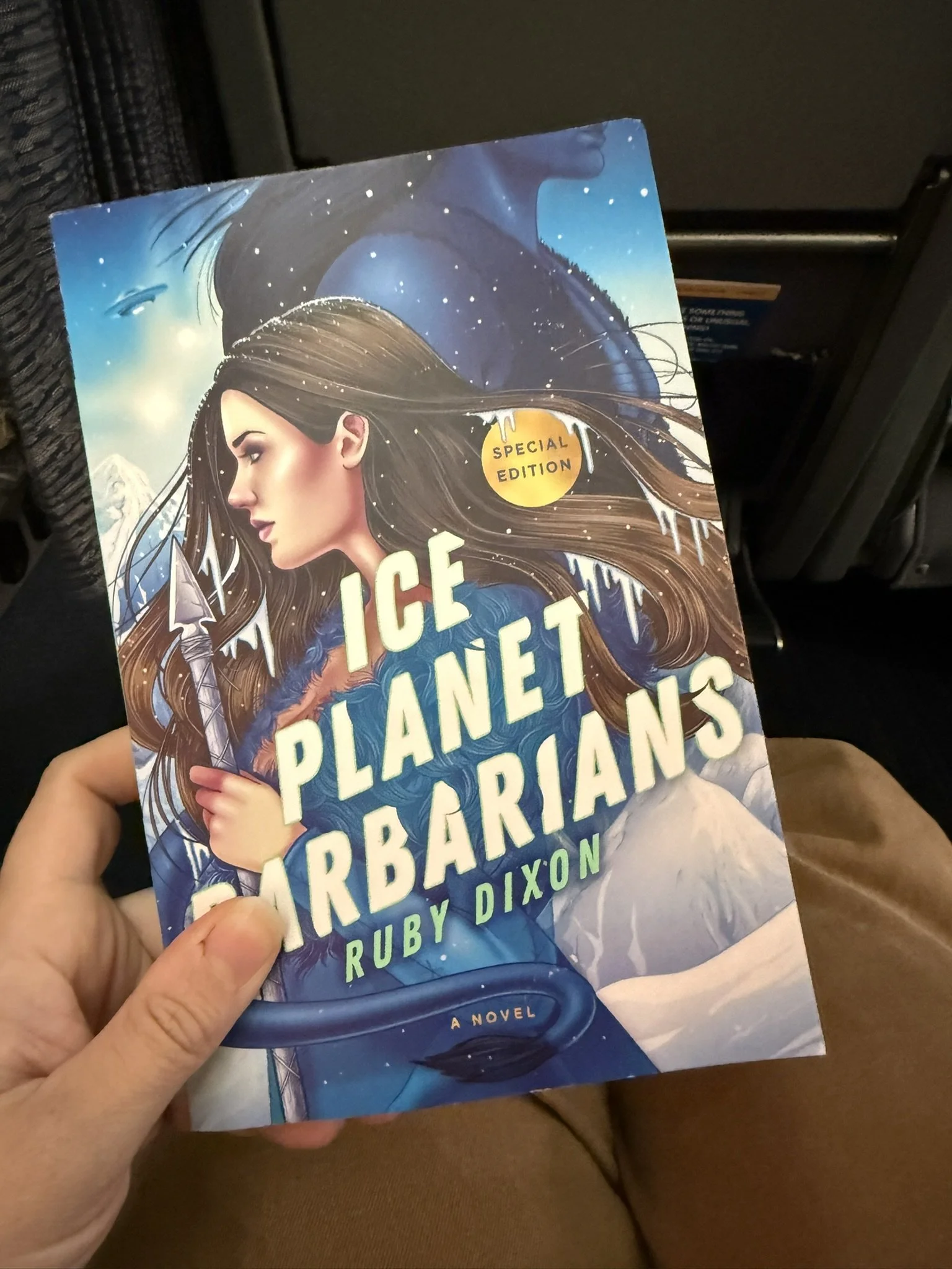 A hand holding the book Ice Planet Barbarians by Ruby Dixon
