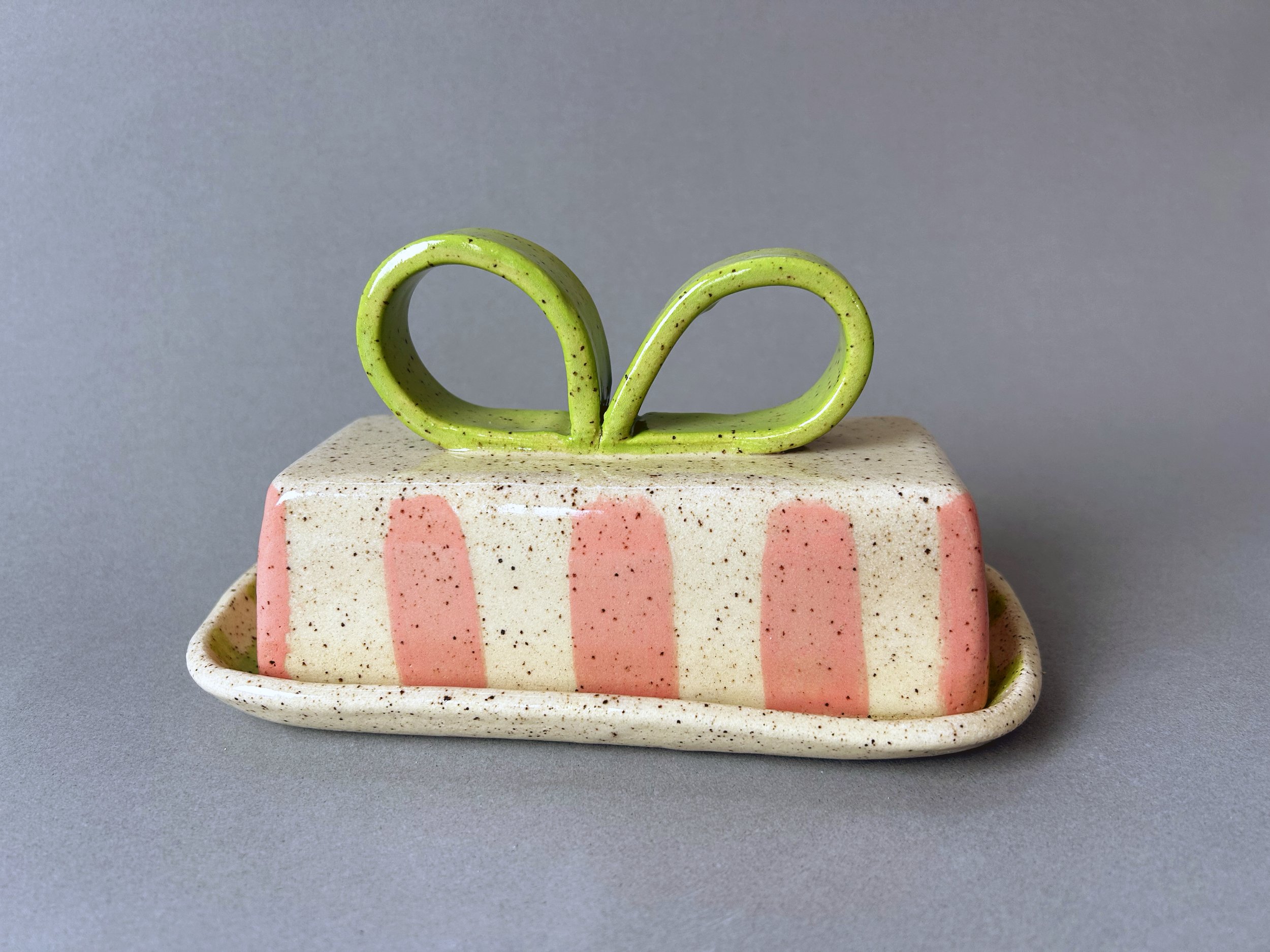 pink stripes and green bow speckled stoneware butterdish.jpg