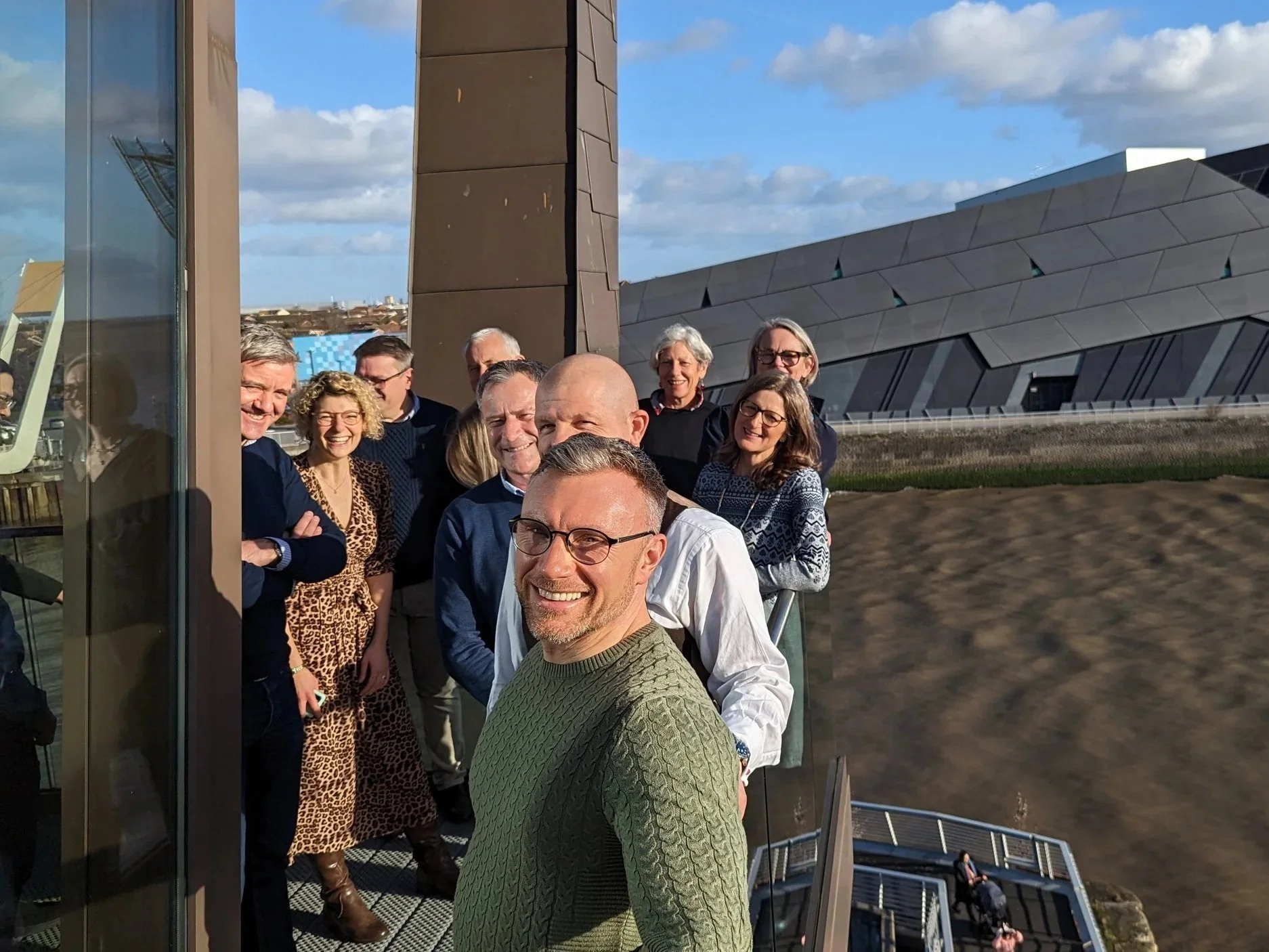 A group of people stood on a balcony outside an innovation centre in Hull as part of a leadership development programme.