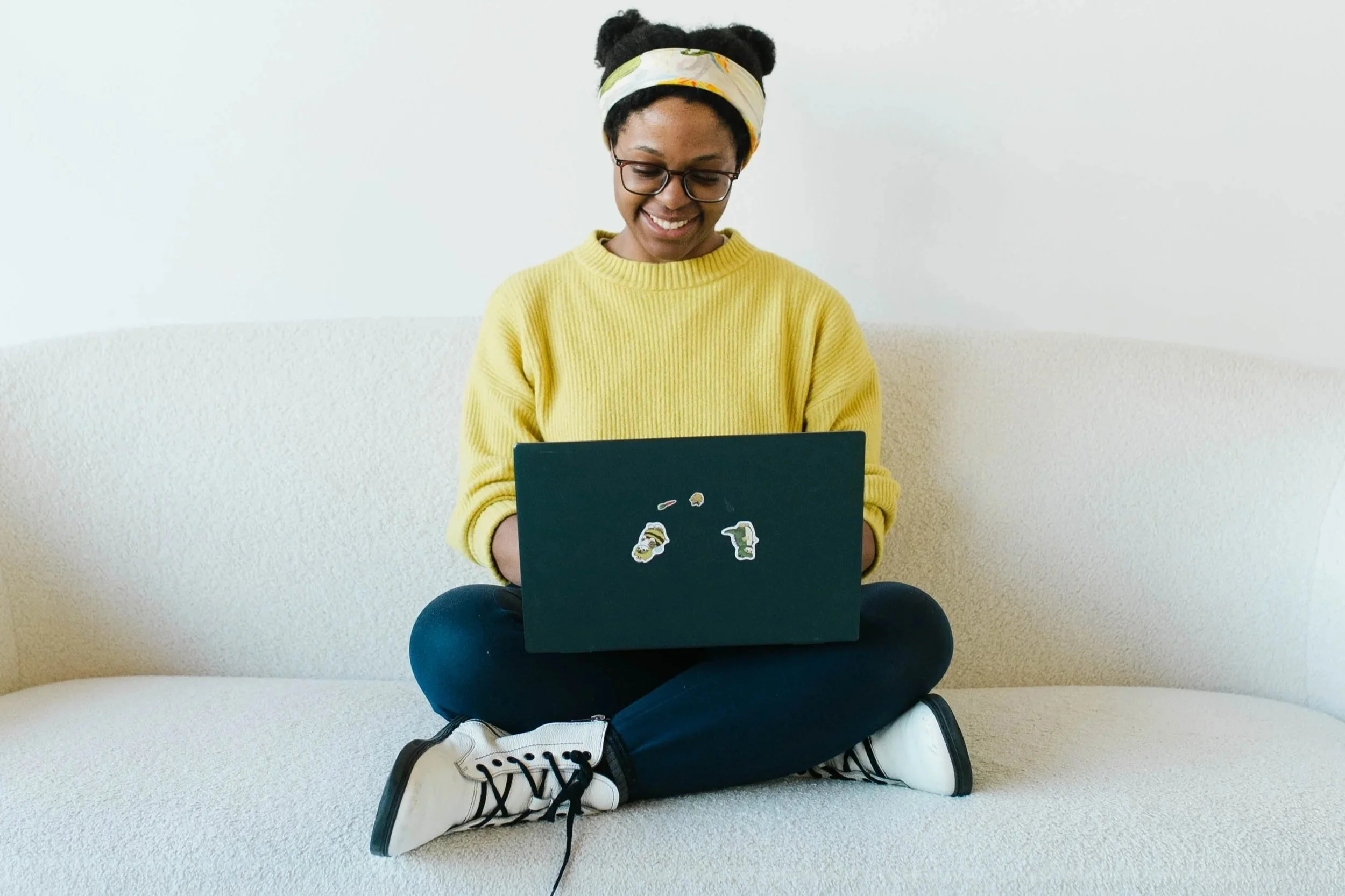 Aneisha smiles down at her lapop.