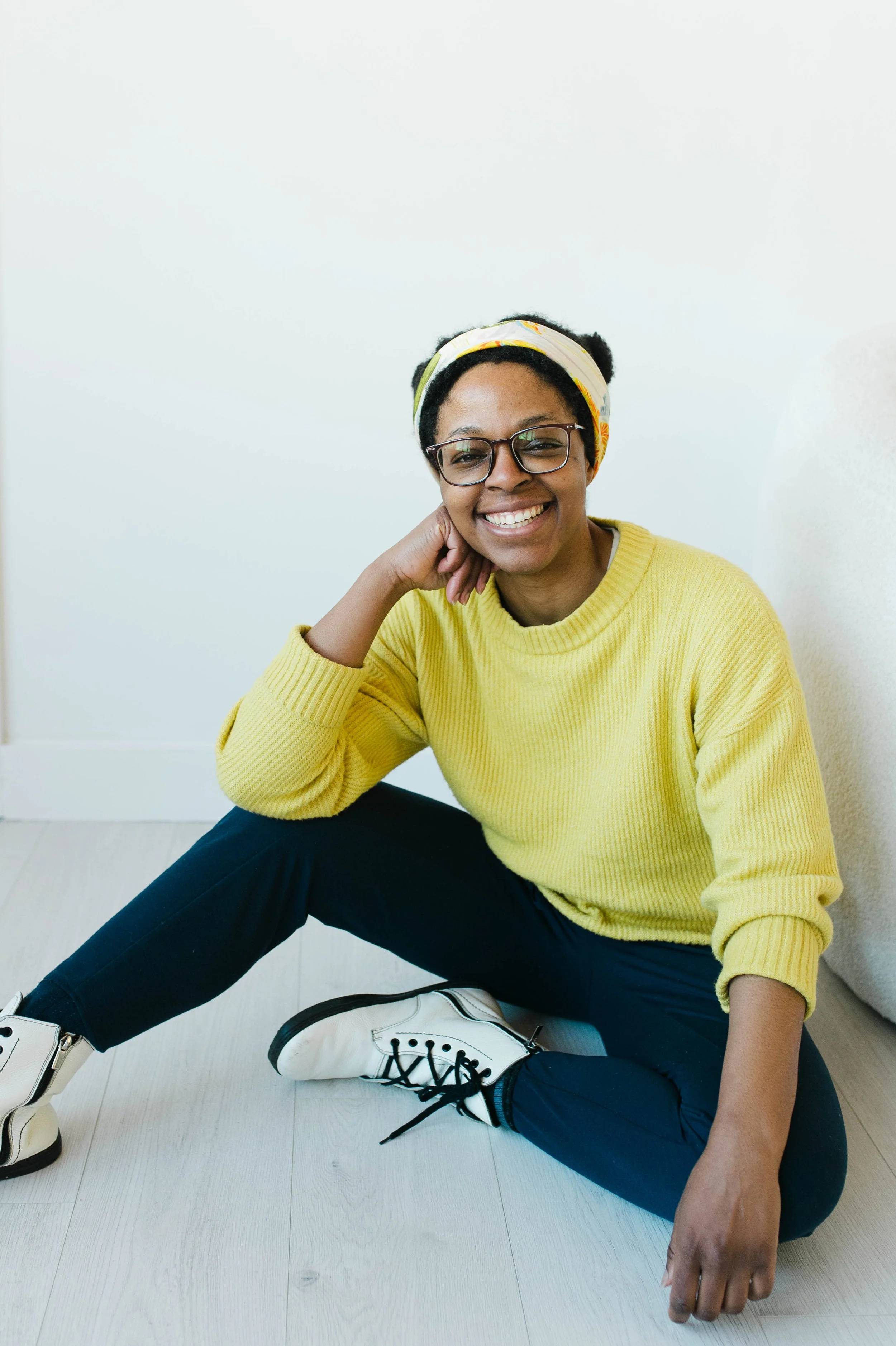 Aneisha sitting on the ground smiling