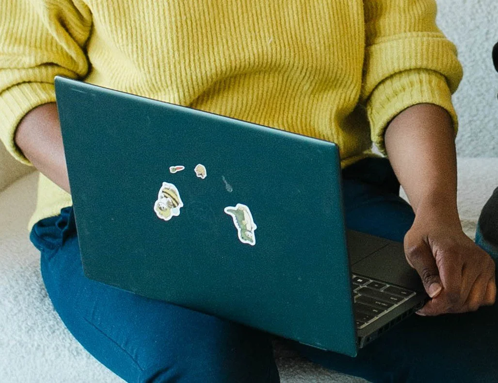 Closeup of Aneisha's laptop with stickers on it