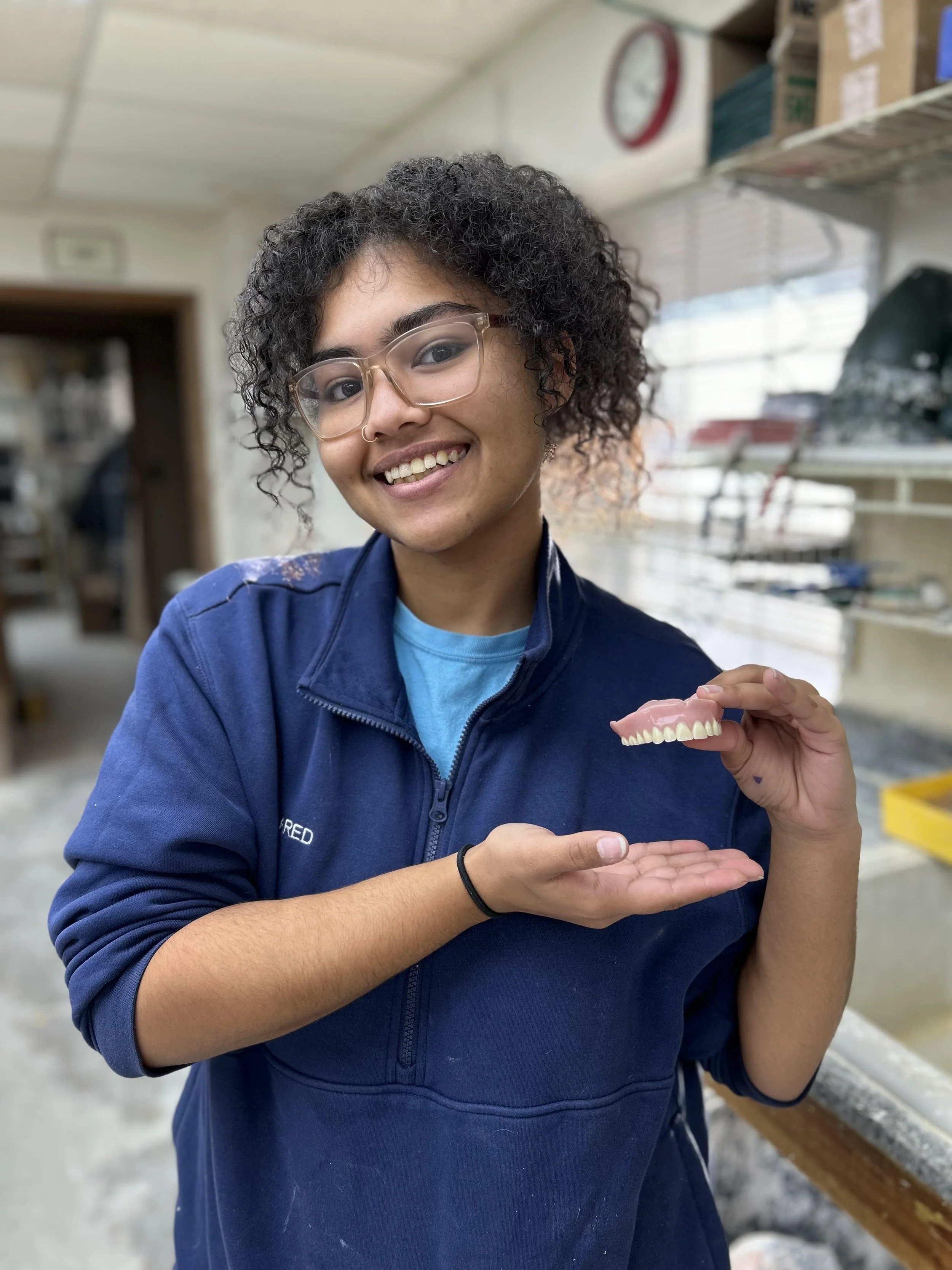 Lab Tech holding  custom denture