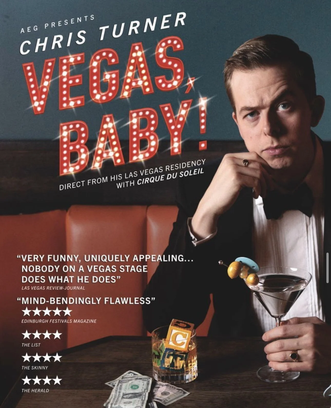 Promotional poster for Chris Turner's Vegas Baby comedy show featuring a man in a tuxedo sitting at a table with a martini, a glass of whiskey with ice cubes, some dollar bills, and colorful dice. The text highlights reviews and show details.
