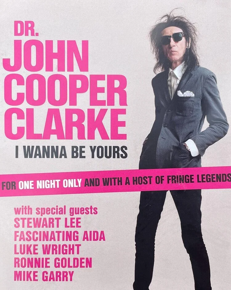 Poster featuring Dr. John Cooper Clarke in a suit with sunglasses and messy hair, advertising a one-night event with special guests Stewart Lee, Fascinating Aida, Luke Wright, Ronnie Golden, and Mike Garry.