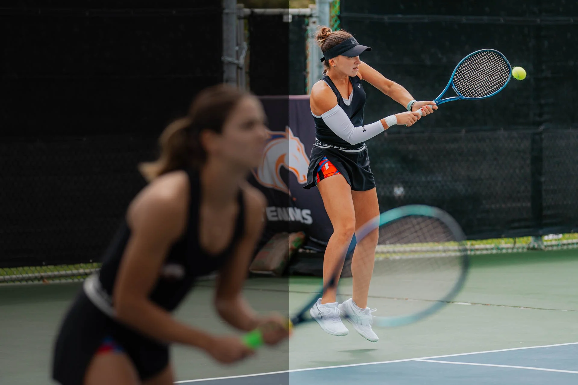 Two women playing tennis, one in the foreground and one in the background hitting a ball