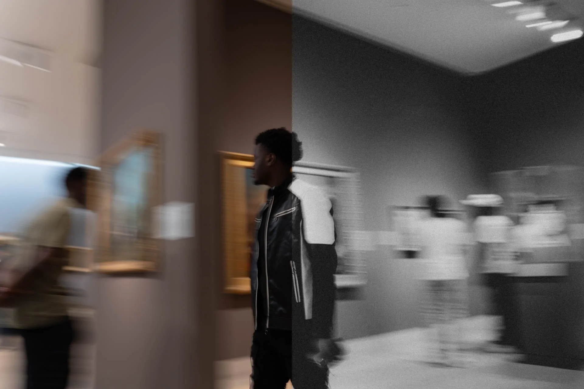 A man walks in a museum hallway, with a part of the image in color and the other in black and white, creating a split visual effect.