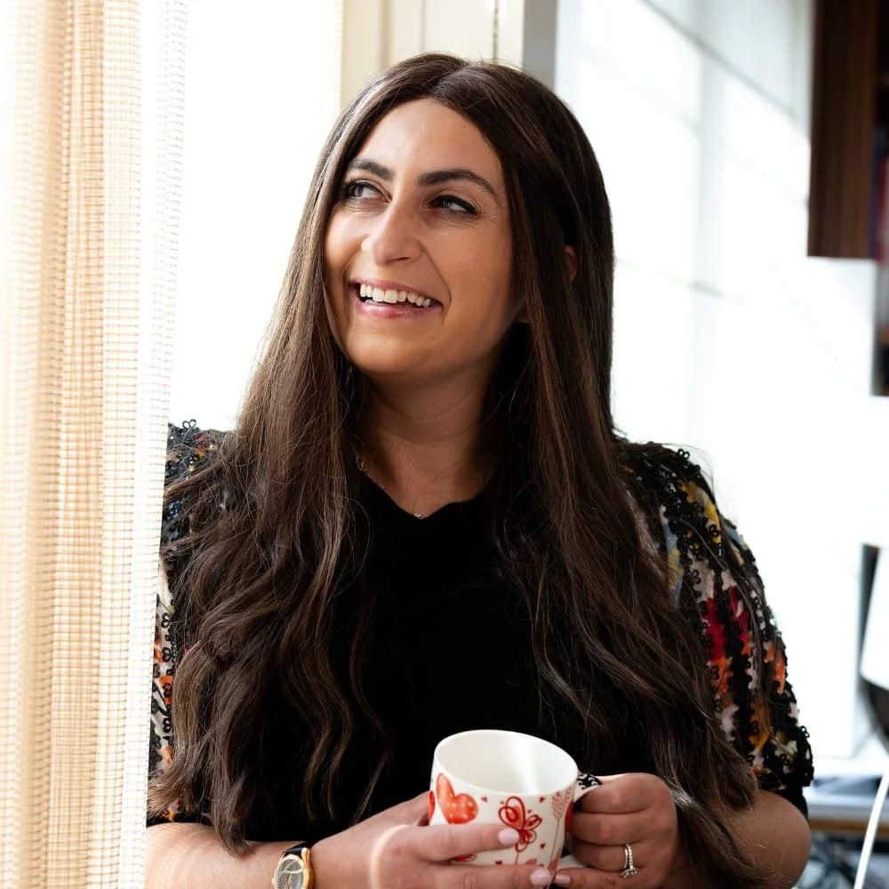 BPD therapist Shira Somerstein LCSW smiling while looking out window