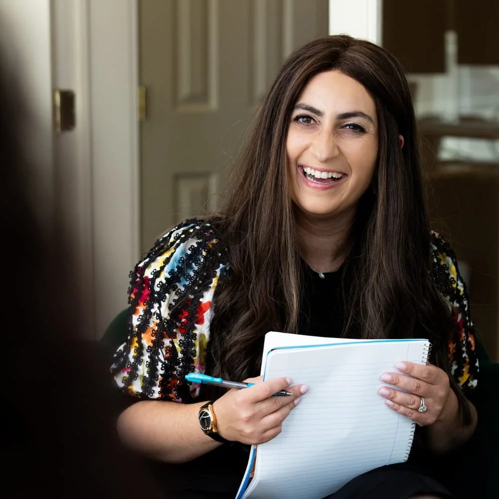 shira somerstein long island therapist with a big smile on her face meeting with client
