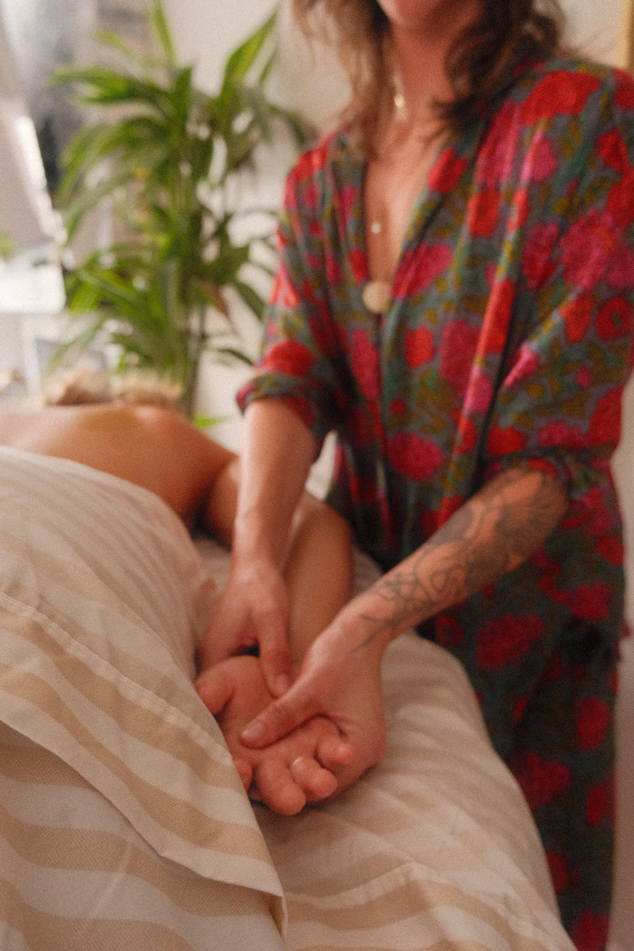 Sam Cuneo, Denver based birth and postpartum doula, gives a massage to a postpartum mother in her home.