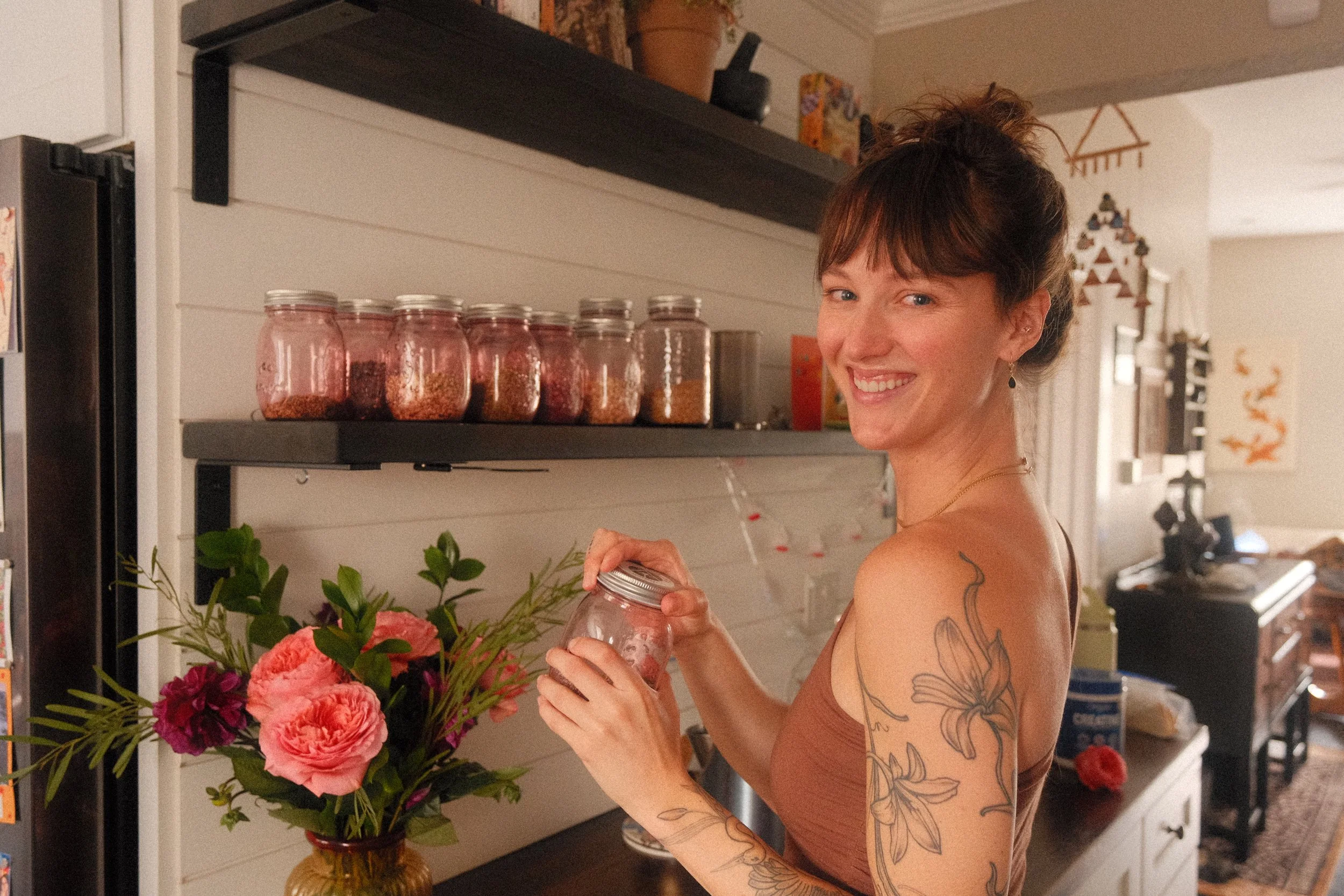 Sam Cuneo, Denver based birth and postpartum doula, holds herbs in her kitchen.
