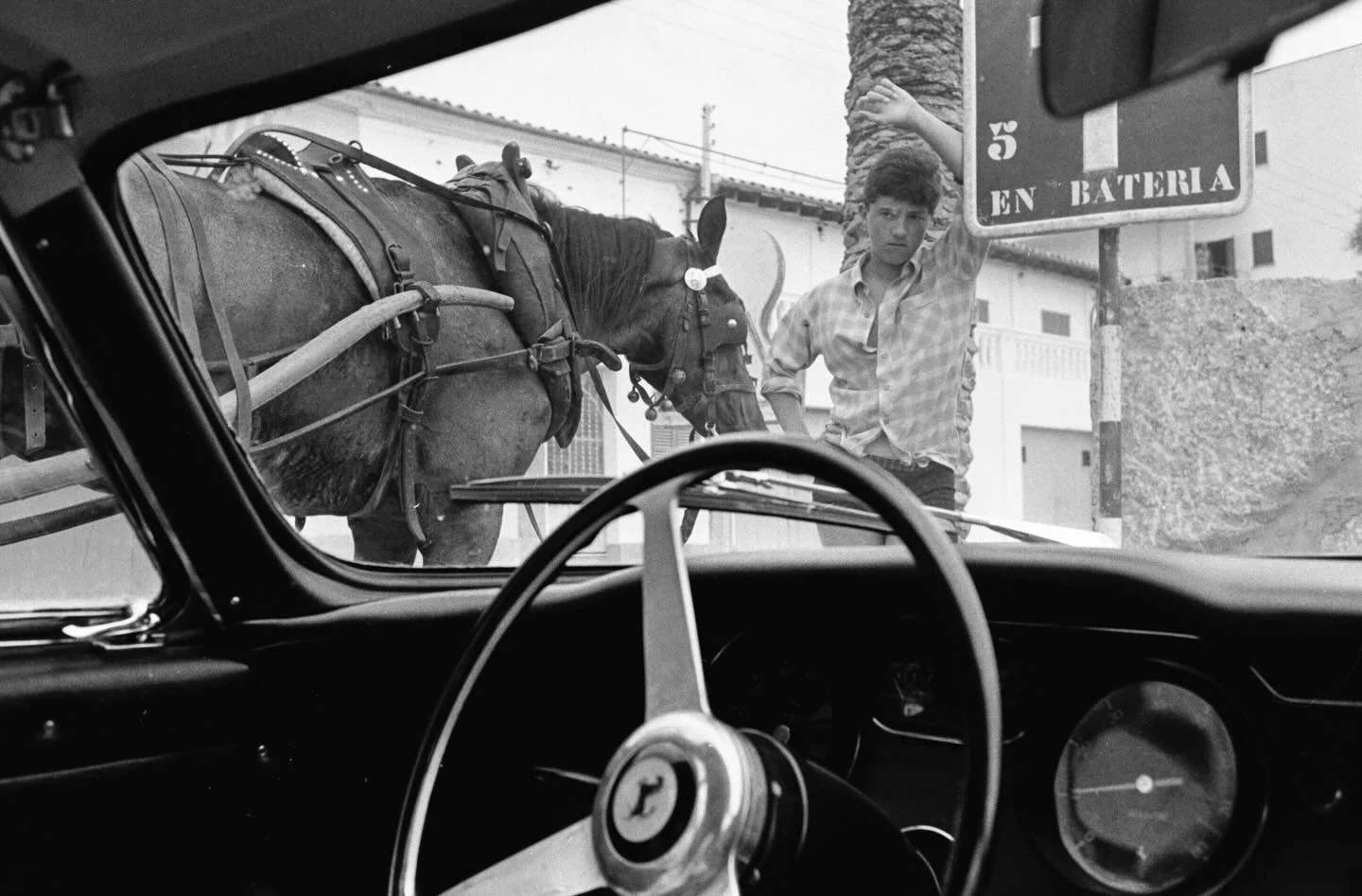 This is one of my favorite photos of my dad&rsquo;s archive. While traveling in Greece via car ferry one summer, he found himself in a friends Ferrari. The horse - the primary mode of transportation on this island by the locals - juxtaposed with the 