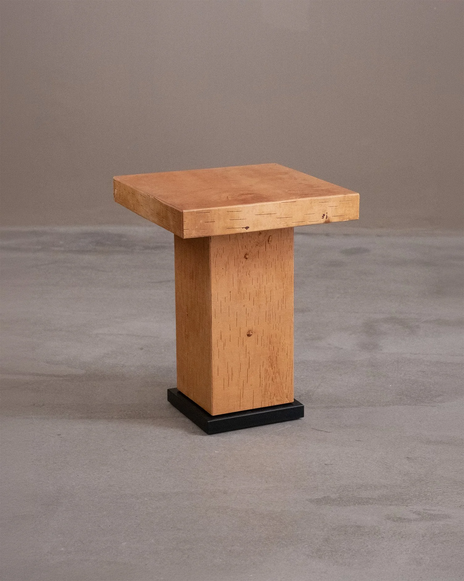 Birch bark side table by Matthew Hensby, with a square top, rectangular column and milled, blackened steel base.