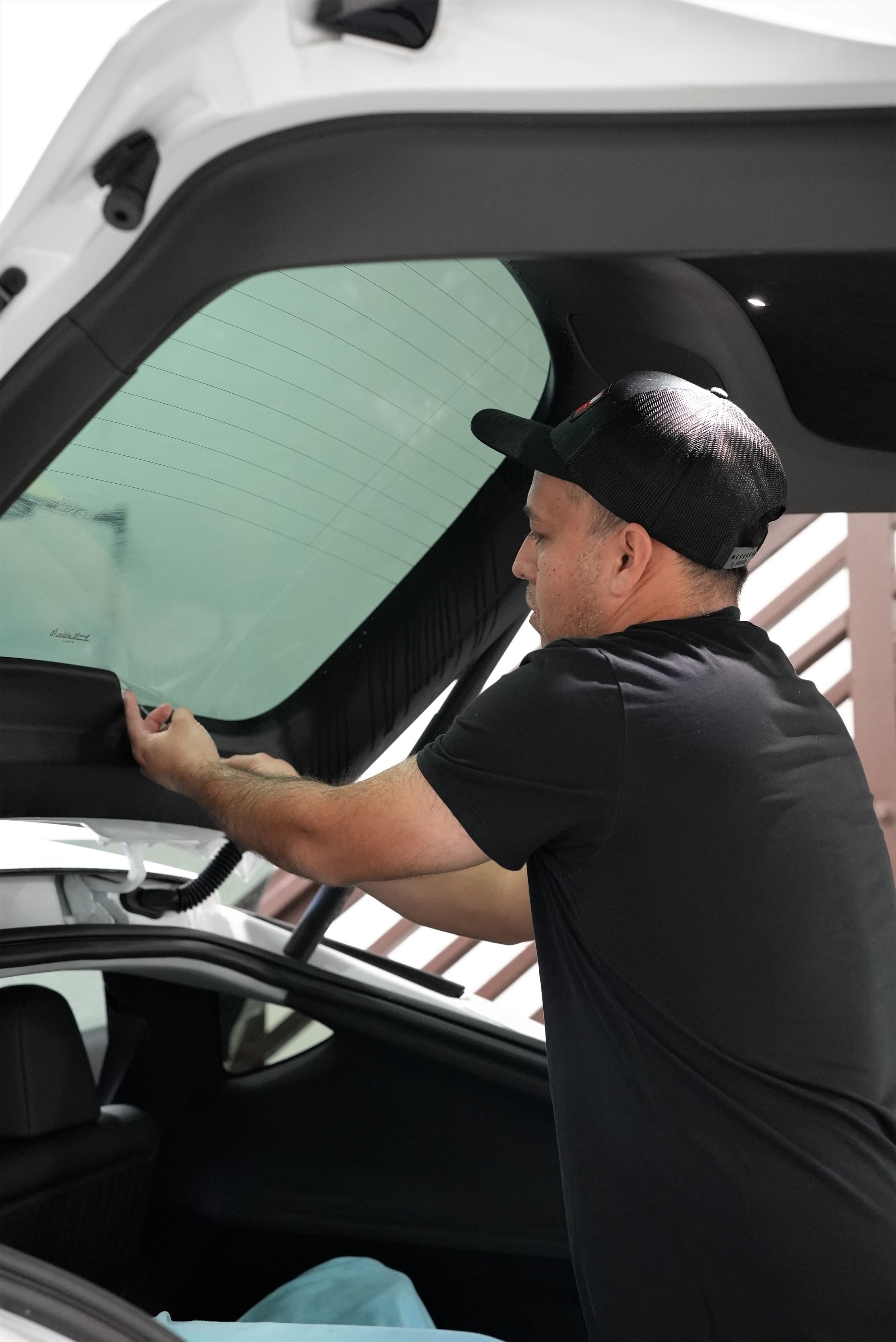 Professional vehicle protection installation inside a car interior with hood open in Campbell, showcasing premium ceramic coating and paint protection film services by Enthusiast Auto Tint.