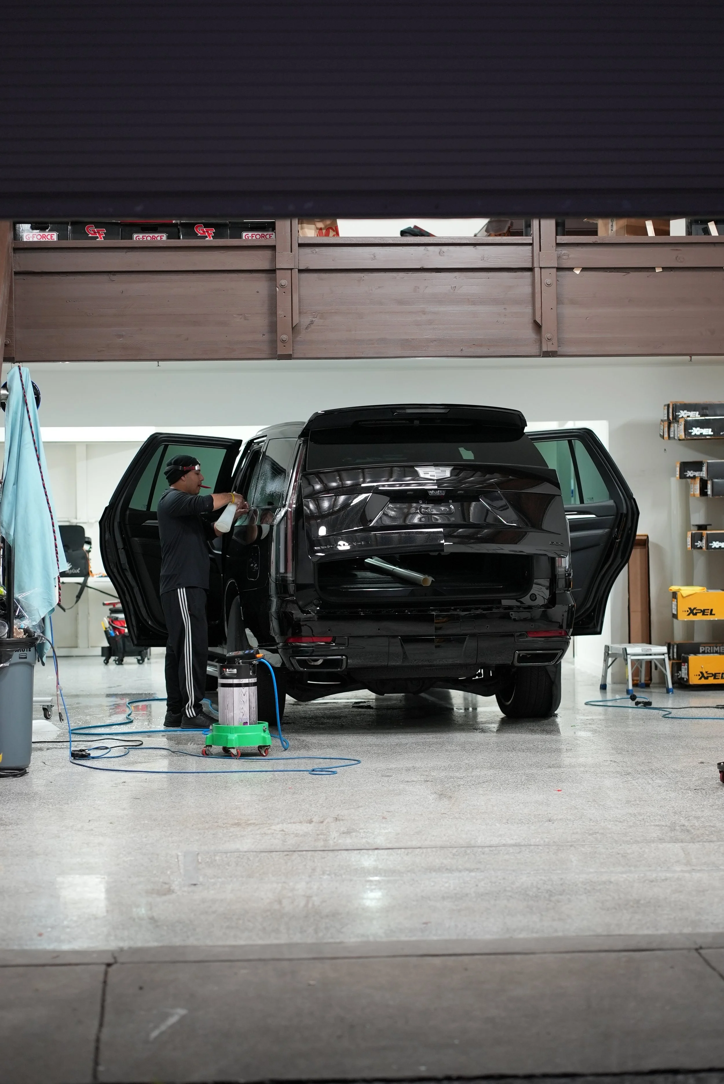 Professional paint protection film and ceramic coating installation on a black pickup truck inside a controlled automotive workshop in Campbell, focusing on premium vehicle protection services for trucks, SUVs, and luxury vehicles at Enthusiast Auto