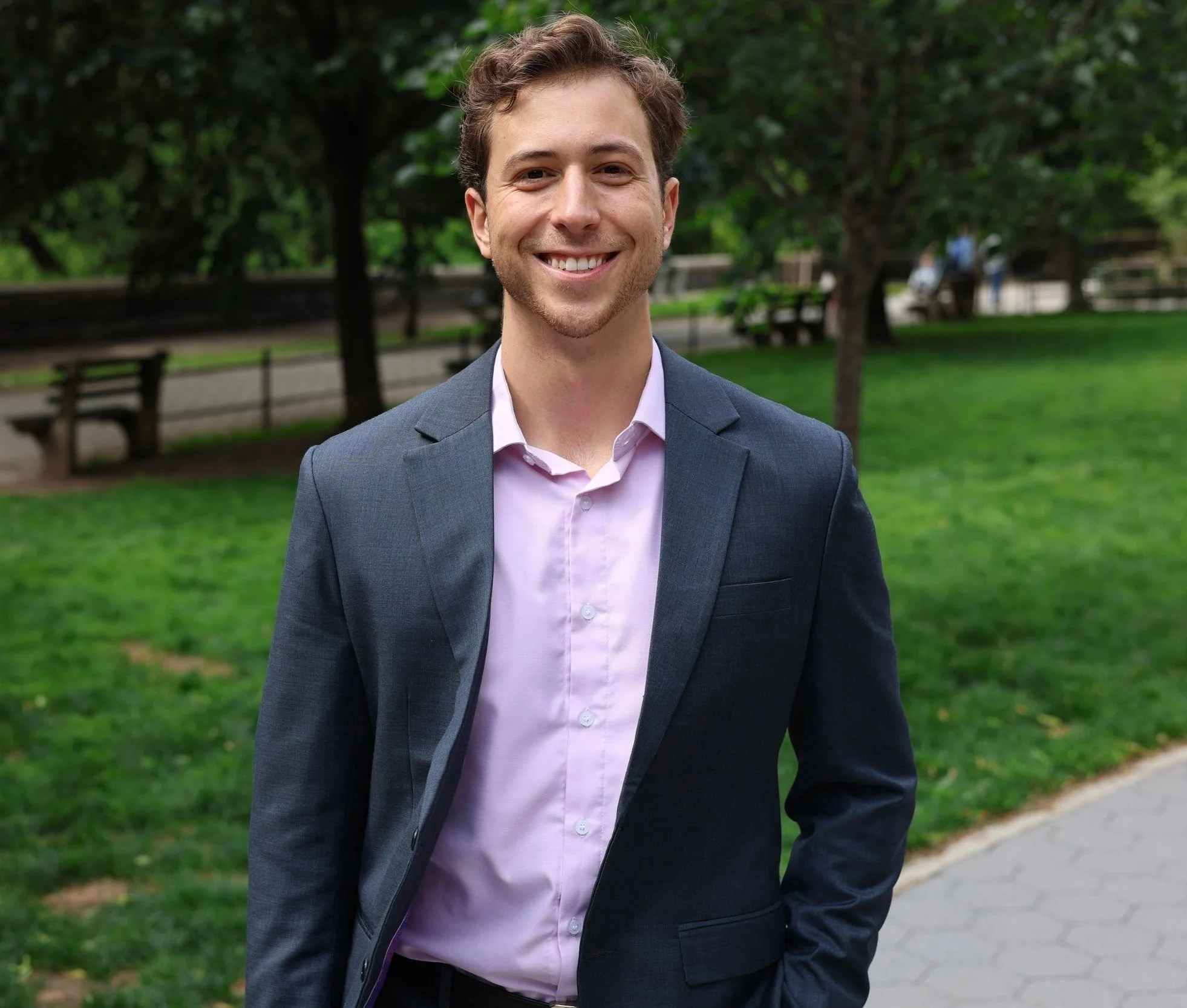 Liam Elkind standing in a park and smiling