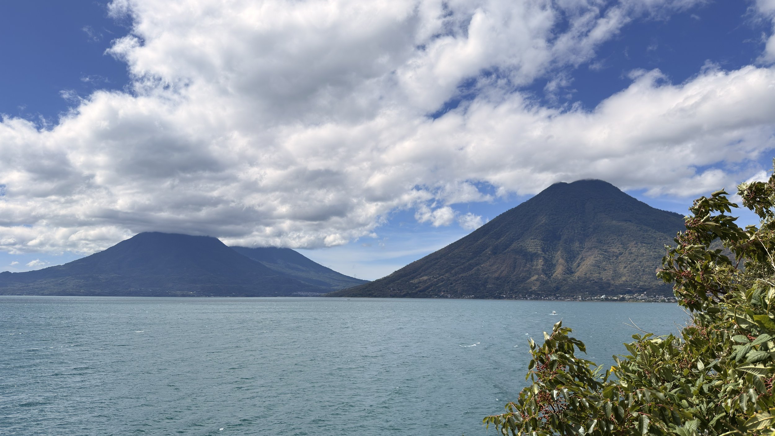 Volcanoes rising over the blue water of Lake Atitlán, Guatemala