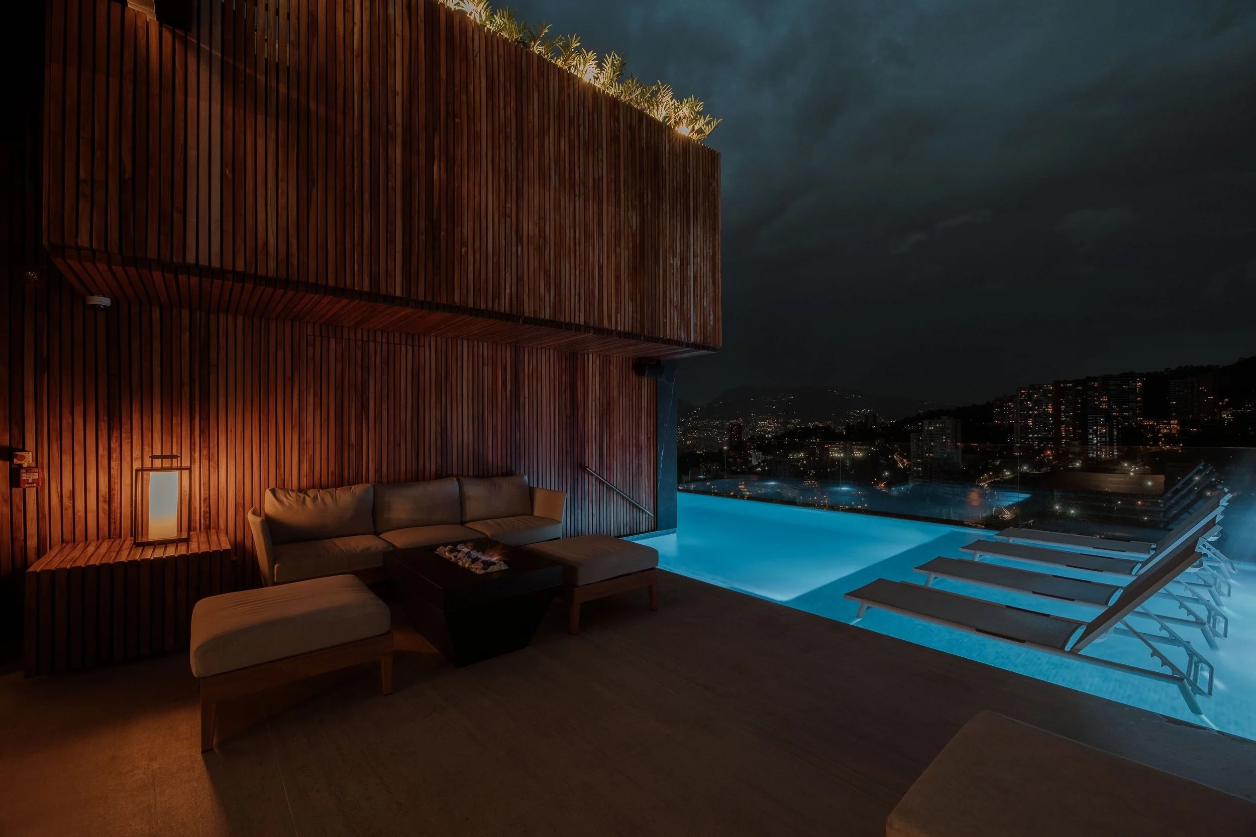 night pool view of Binn Hotel Medellin with skyline