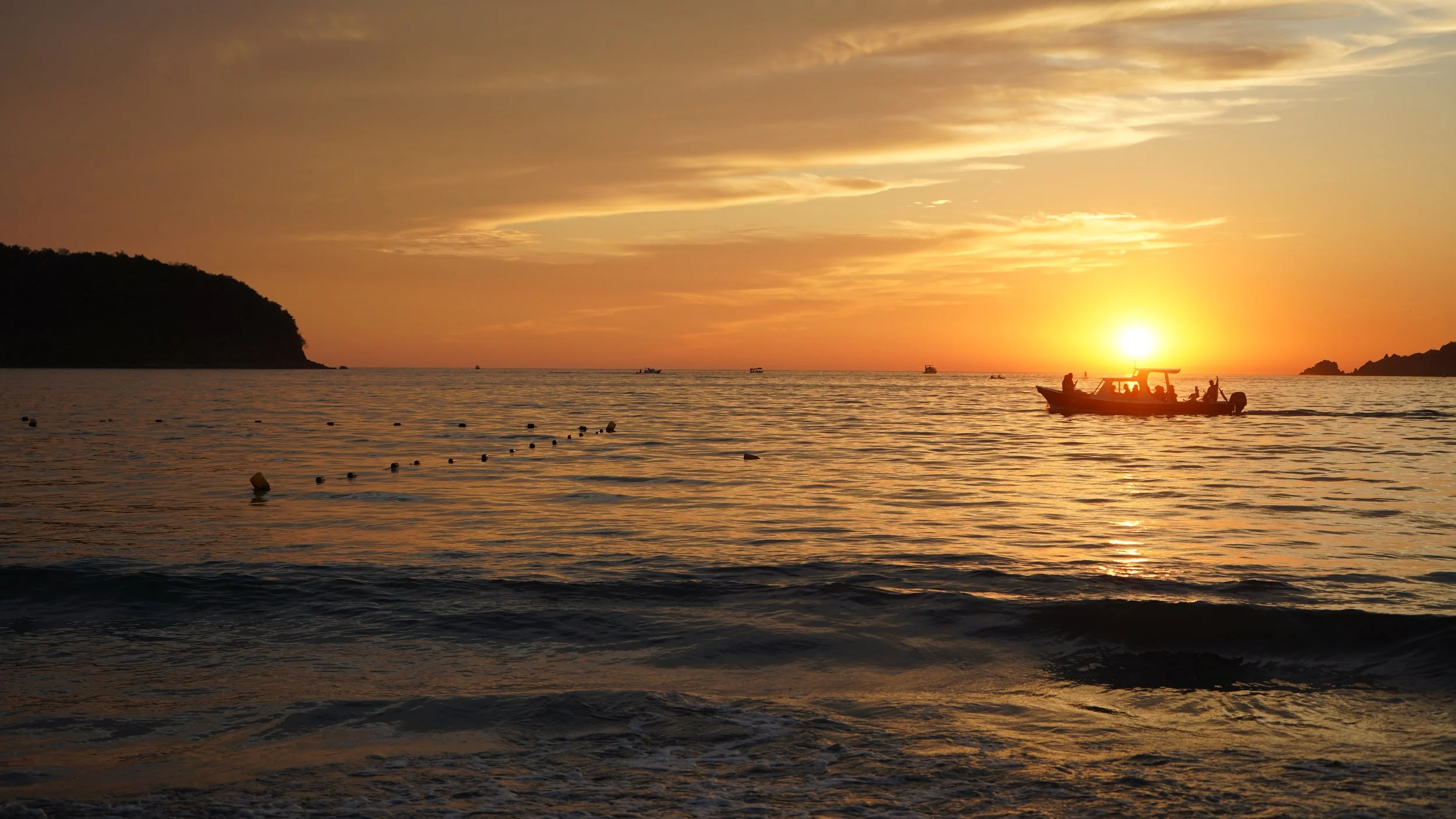 Sunset boats in Playa La Ropa, Zihuatanejo Mexico taken by Seek Mas.