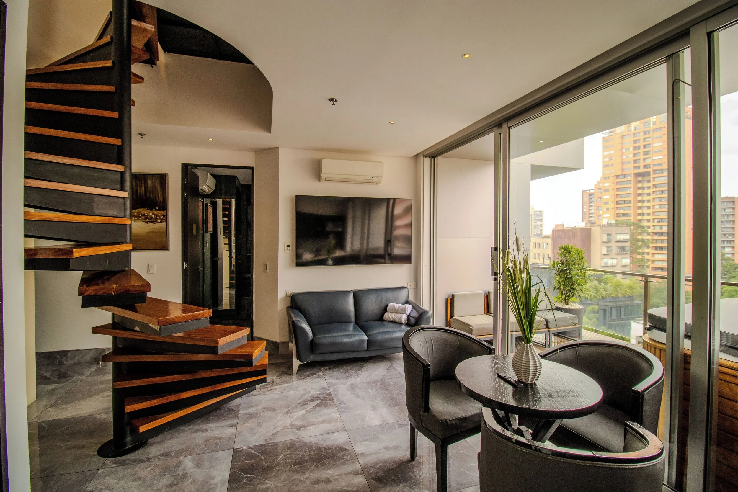 Spiral staircase in Haven Medellin hotel views of the city scape 