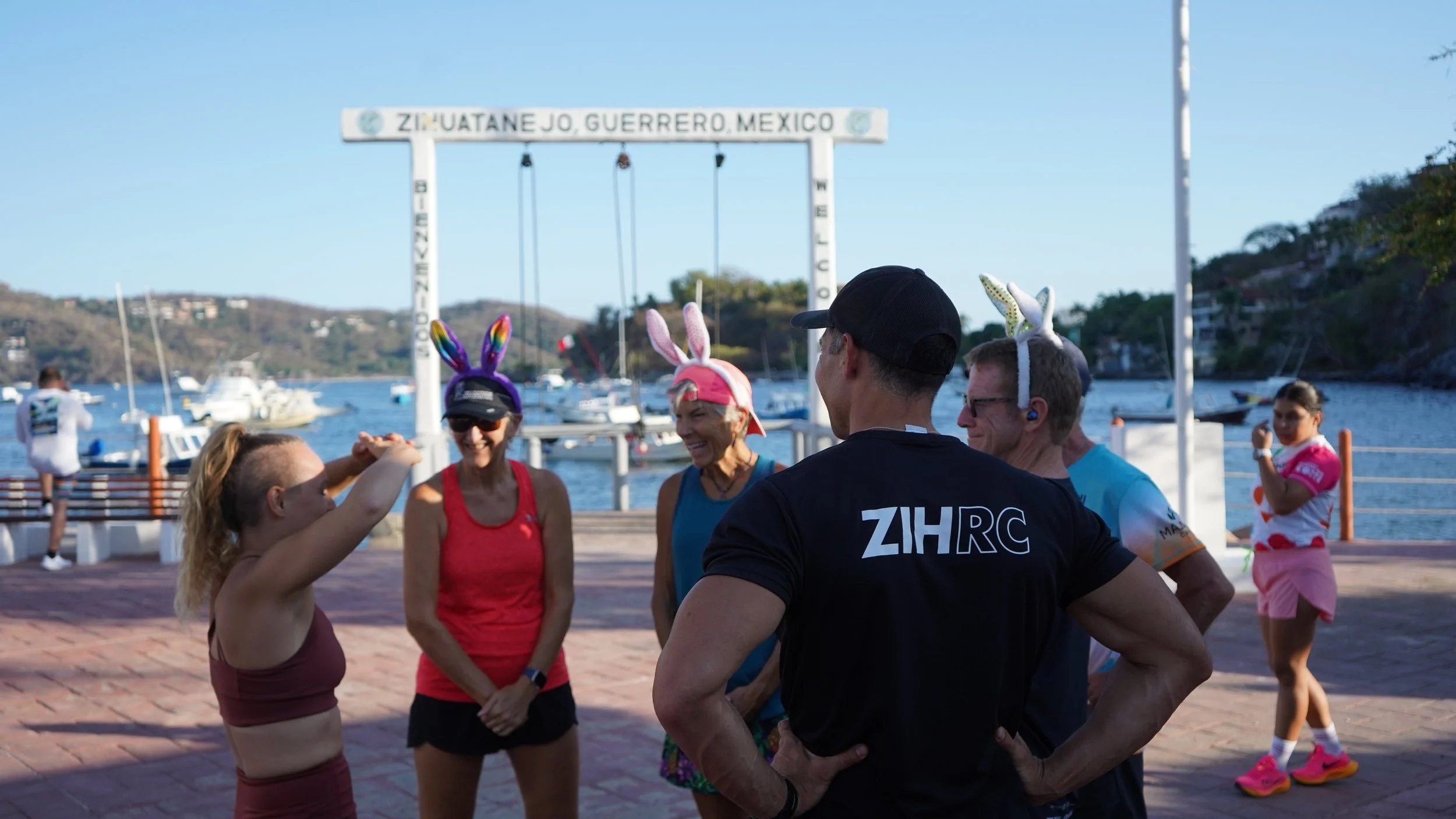 ZIHRC at Zihuatanejo Muelle - club of canadian, american, and mexican runners getting ready for weekly run smiling