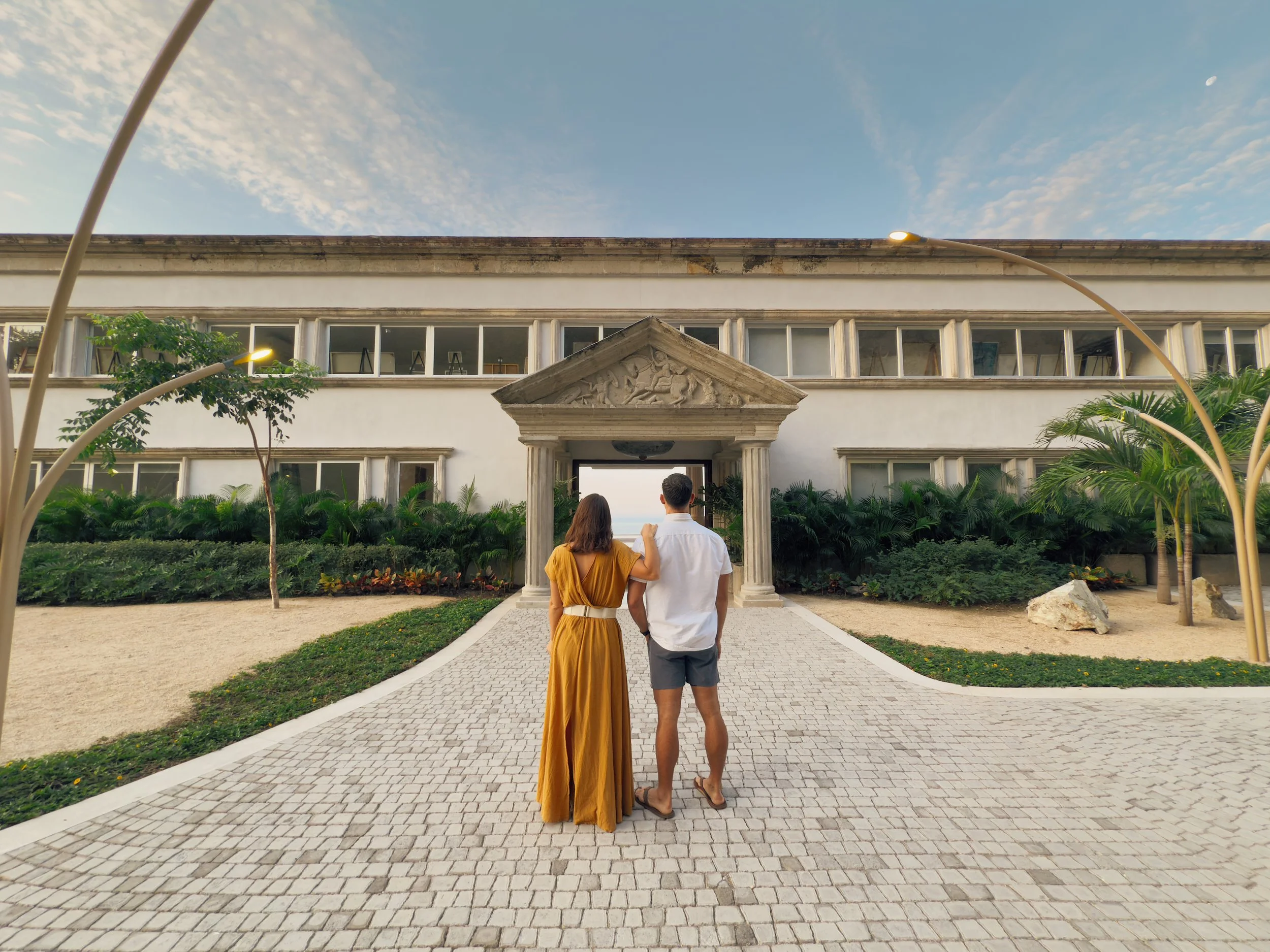 Man and woman back's facing in front of parthenon in zihuatanejo mexico.