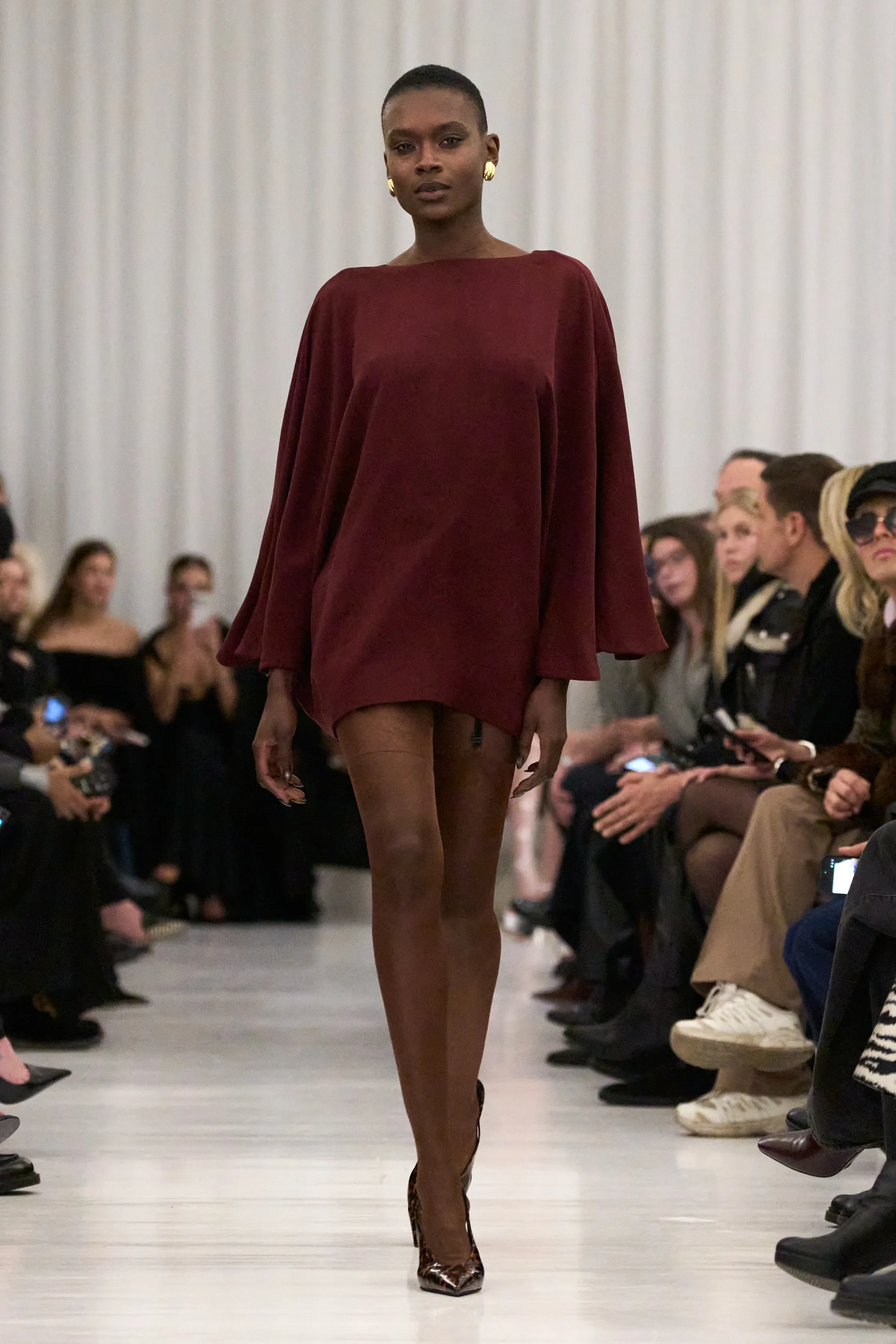 Elisse hand sewed an invisible hem on the sleeves of the garment