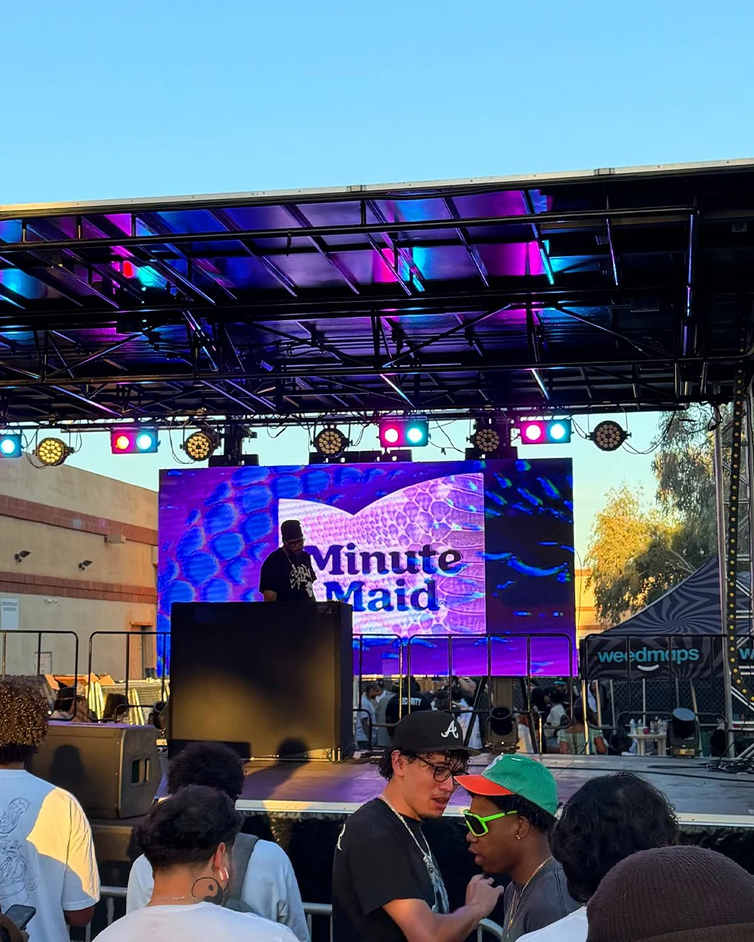 DJ on stage with Minute Maid on screen