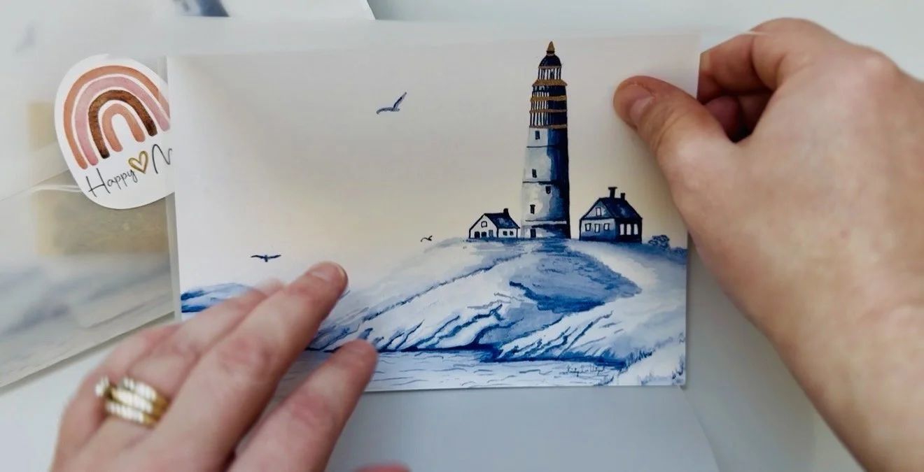 a 5x7 art print is shown with a lighthouse painted in delft blue