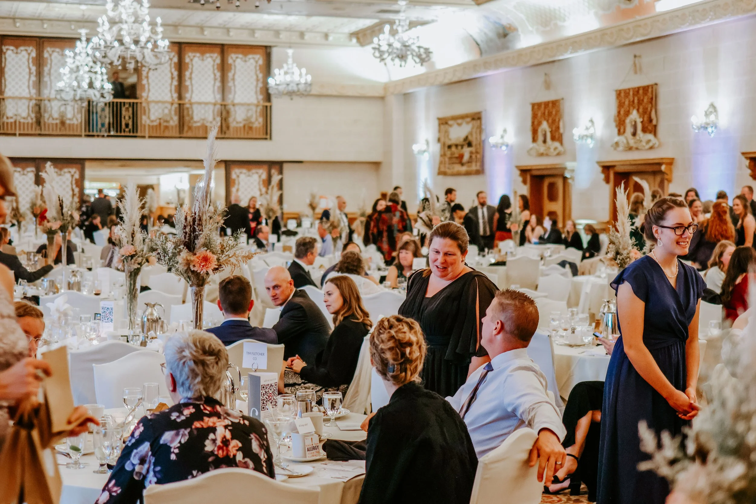 Guests socializing and mingling at a Selah Place gala fundraiser in Winnipeg, gathered in an elegant banquet hall