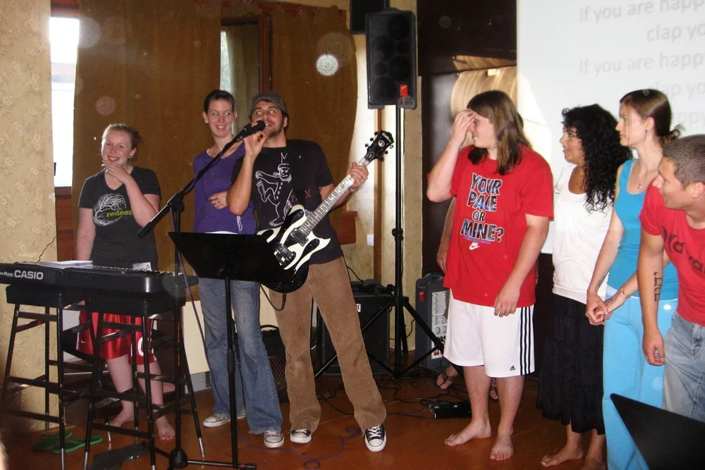   Josh leading music on a borrowed electric guitar wearing a Where the Wild Things Are t-shirt. Classic.  