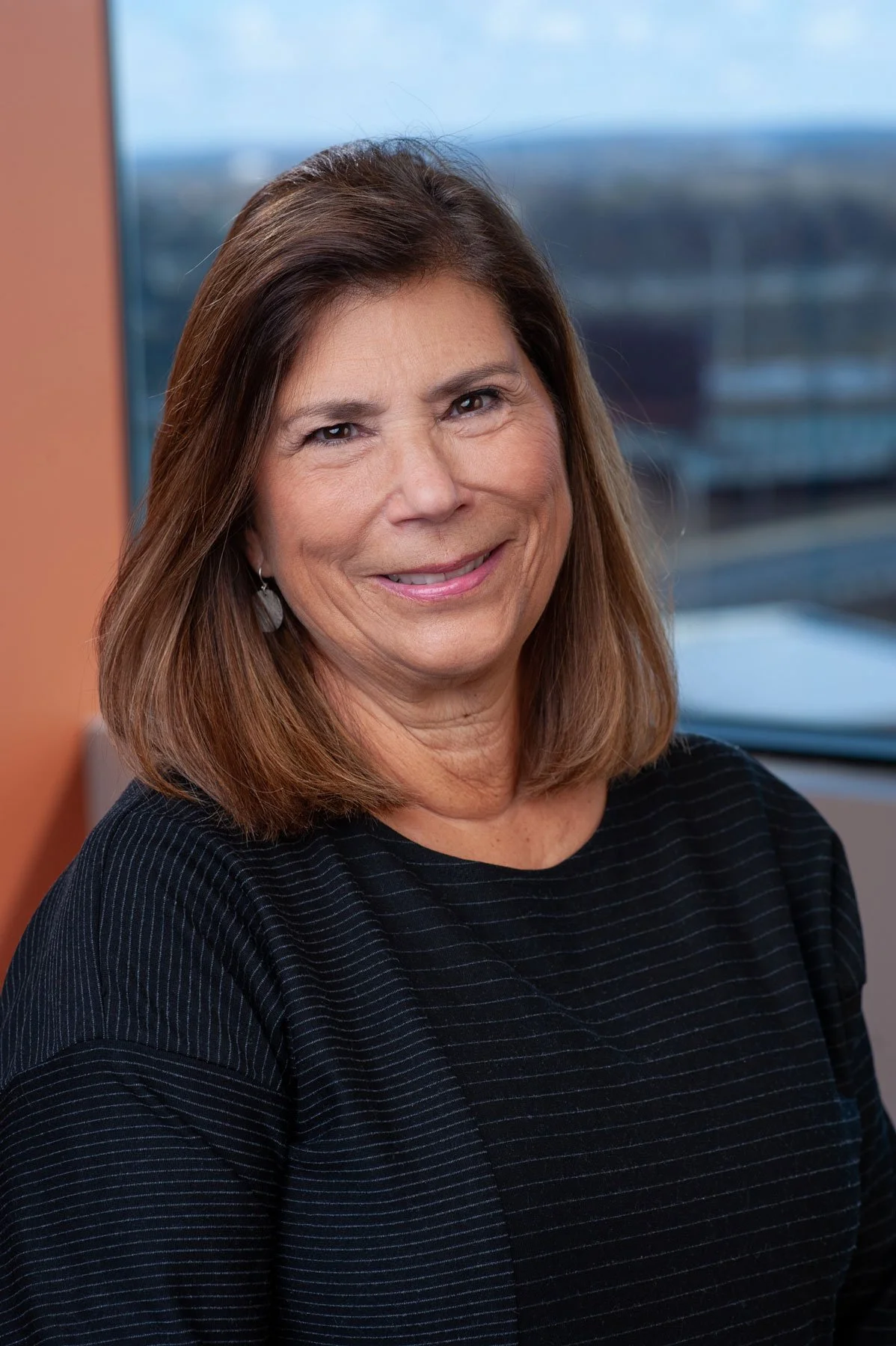 Susan smiling at the camera wearing a black shirt.