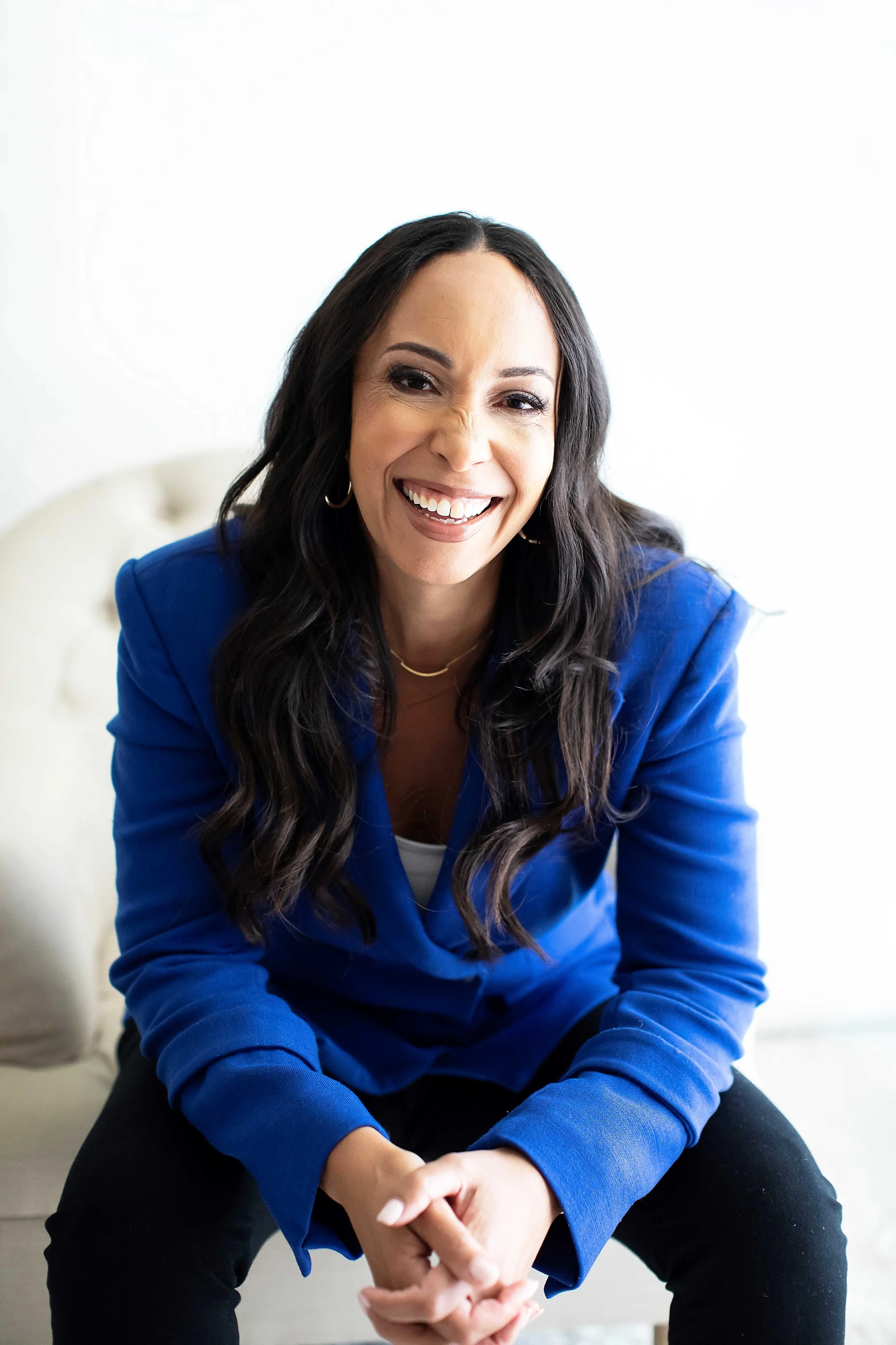 Lindsay smiling at the camera wearing a blue blazer.